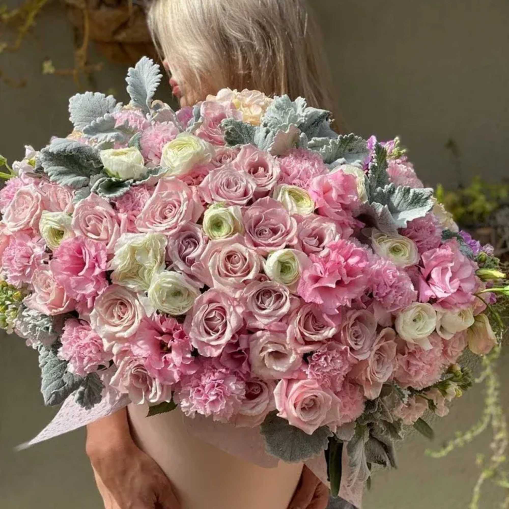 Pink heaven floral arrangement consists of two types of roses, hydrangea, ranunculus