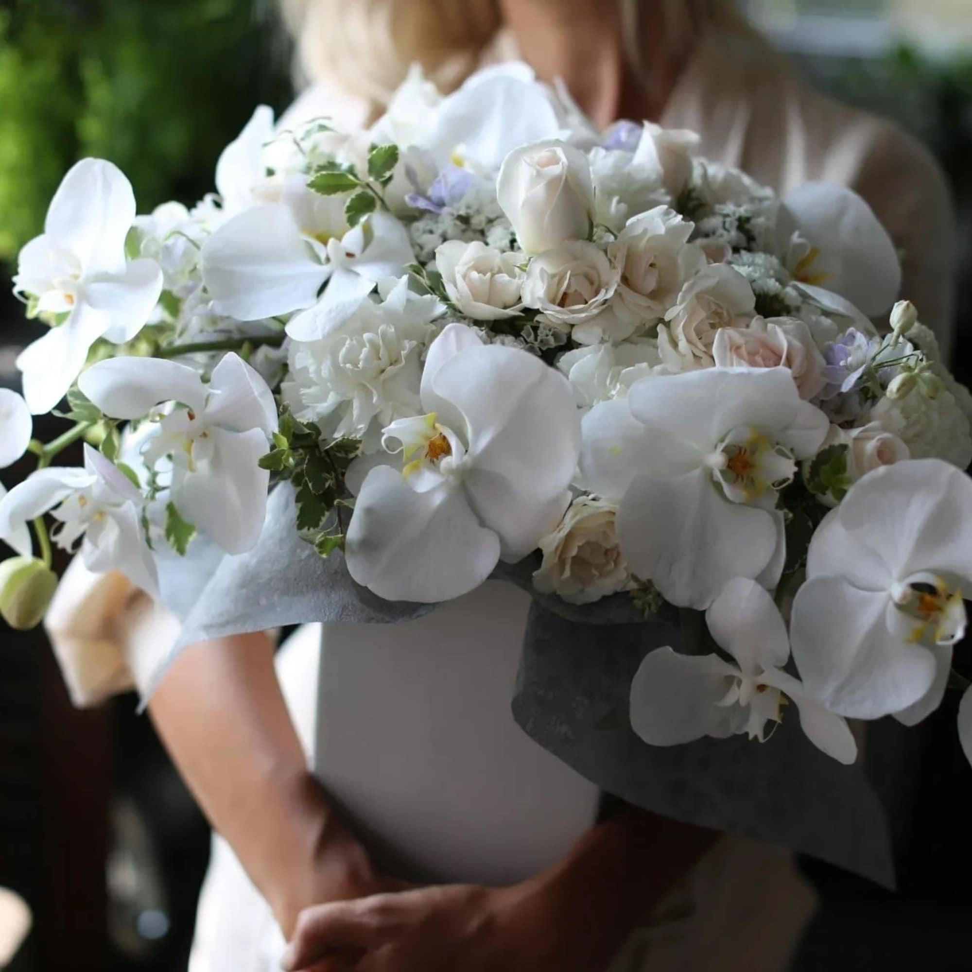 Nella is a stunning arrangement of white orchids mixed with white roses
