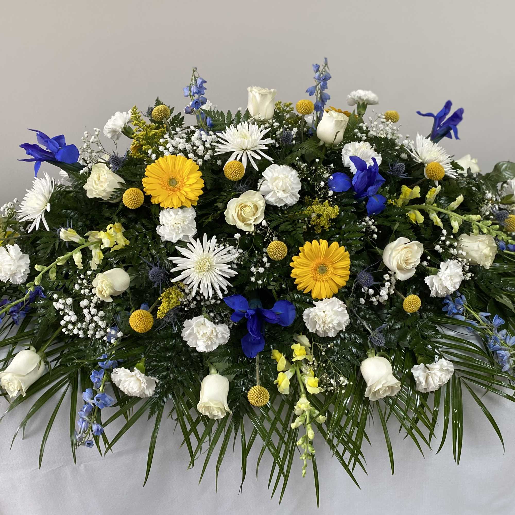 Blue and White flowers with a pop of yellow gerberas.