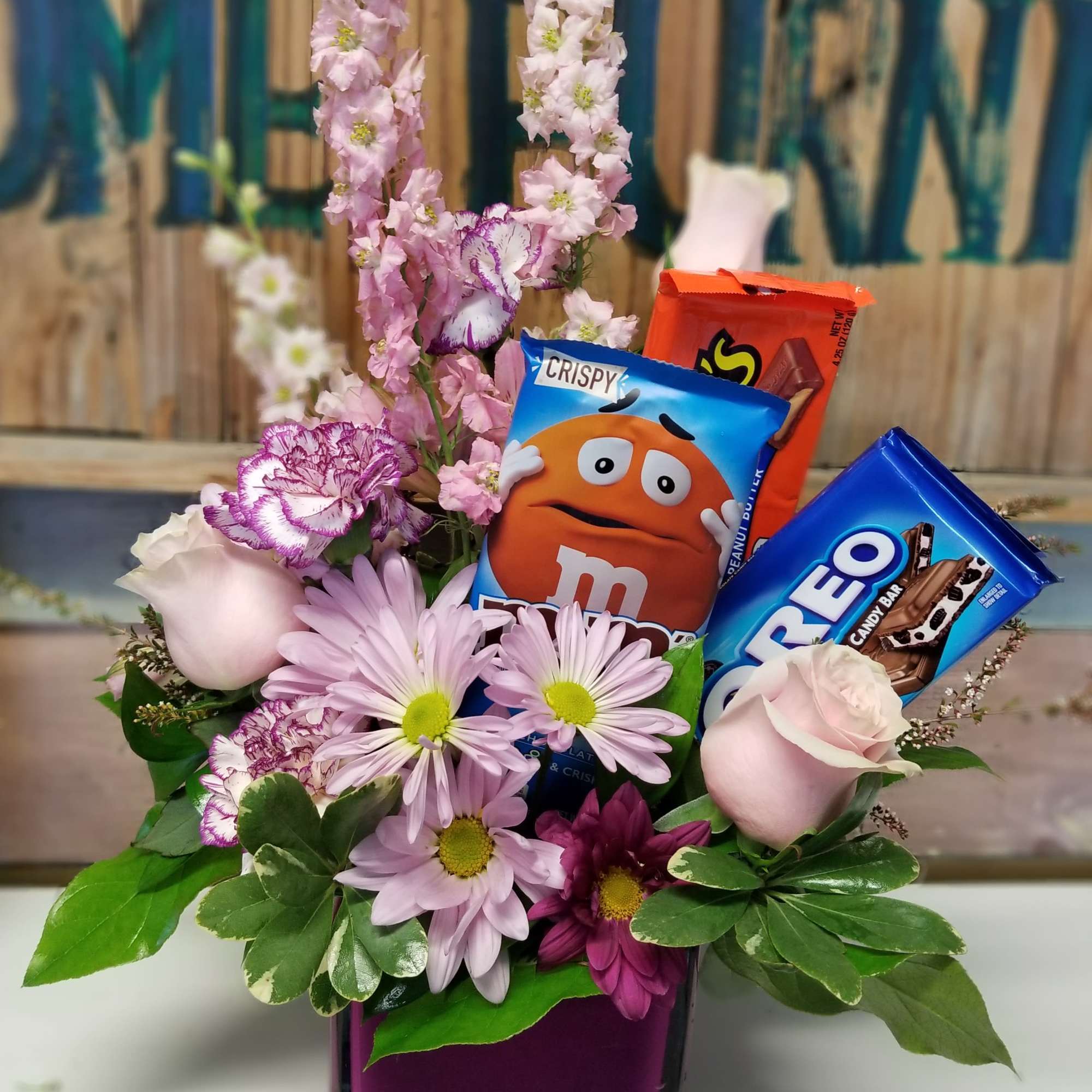 Brighten someone&#039;s day with Flowers and Chocolates Bars, in a glass vase