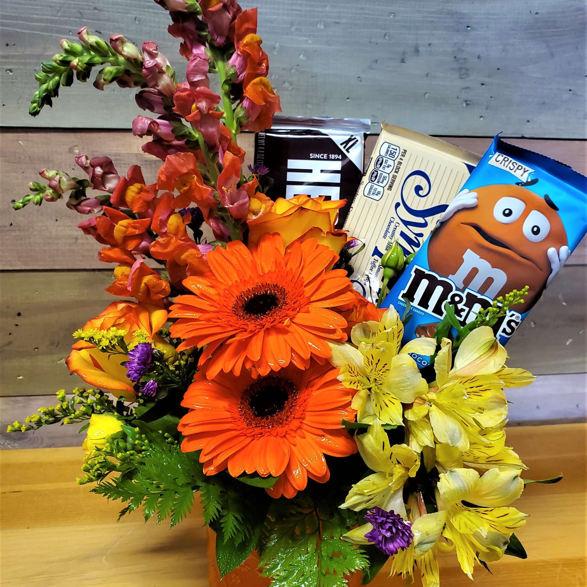 Brighten someone&#039;s day with Flowers and Chocolates Bars, in a glass vase
