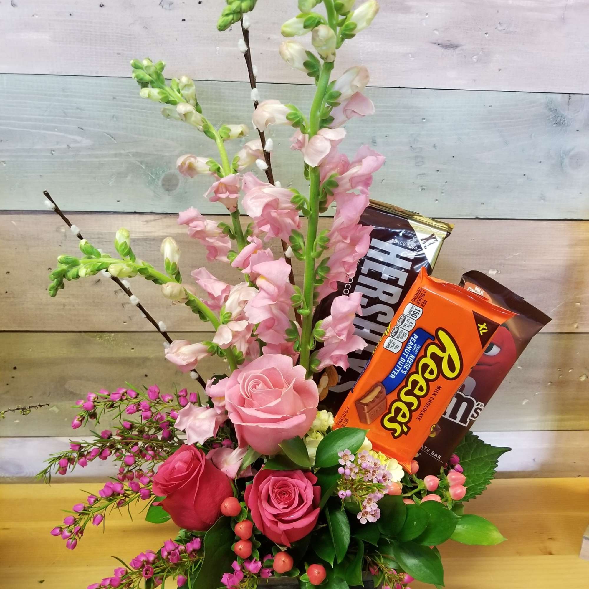 Brighten someone&#039;s day with Flowers and Chocolates Bars, in a glass vase