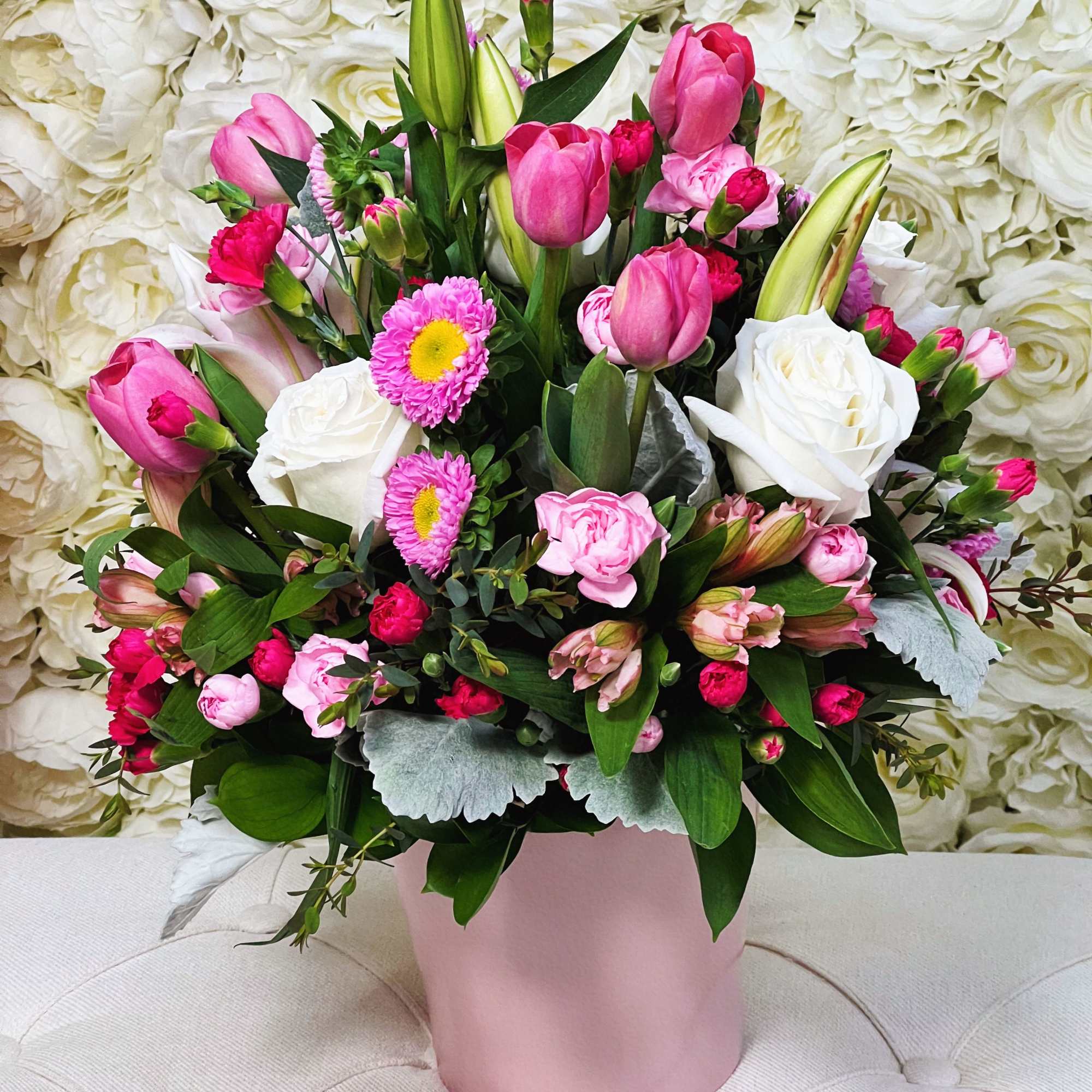 A delicate floral arrangement in soft pink and white tones that evokes