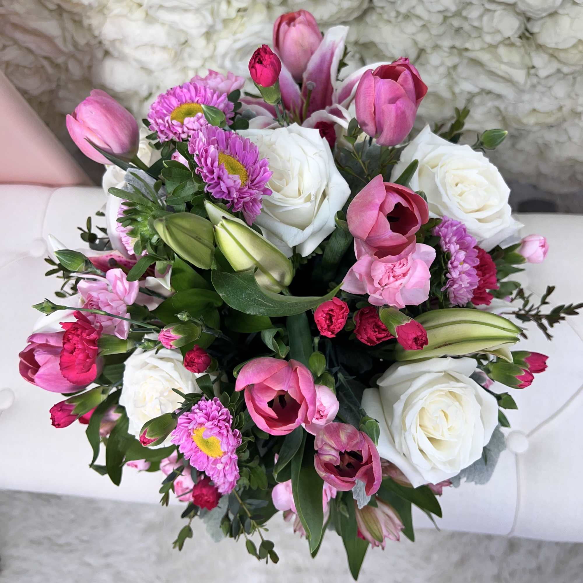 A delicate floral arrangement in soft pink and white tones that evokes