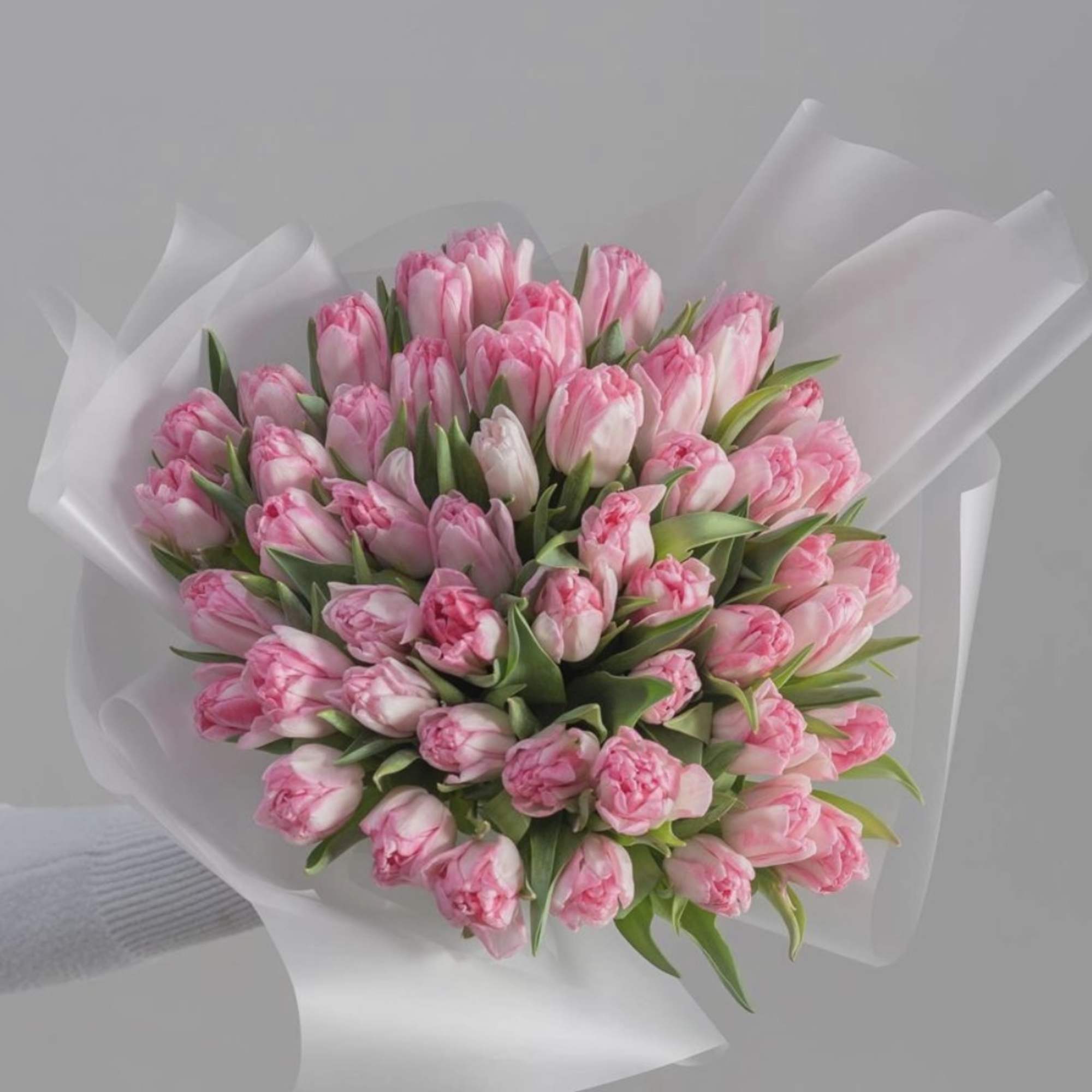 A bouquet of light and gentle-colored tulips represents elegance, purity, and tranquility.