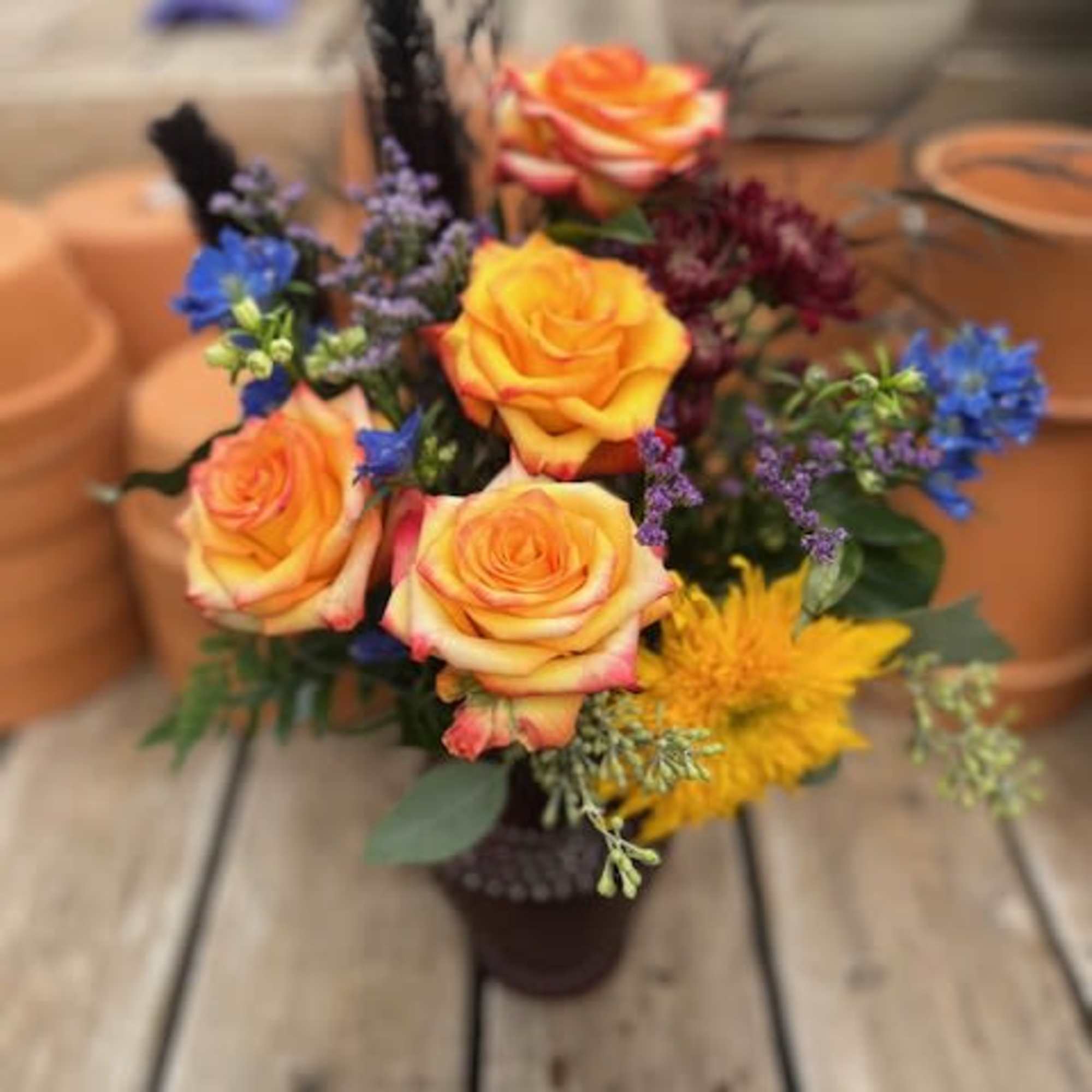 Roses take centerstage but everything else makes it whole! A bright mixture