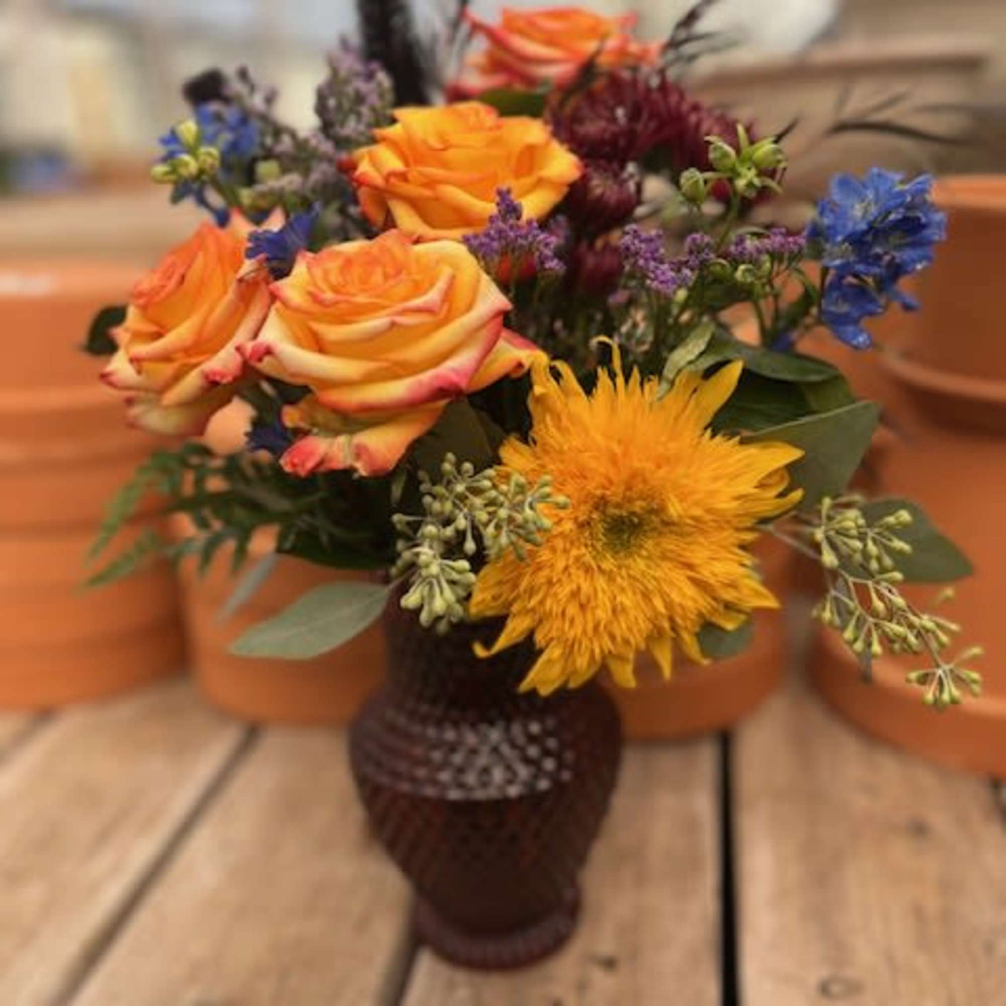 Roses take centerstage but everything else makes it whole! A bright mixture