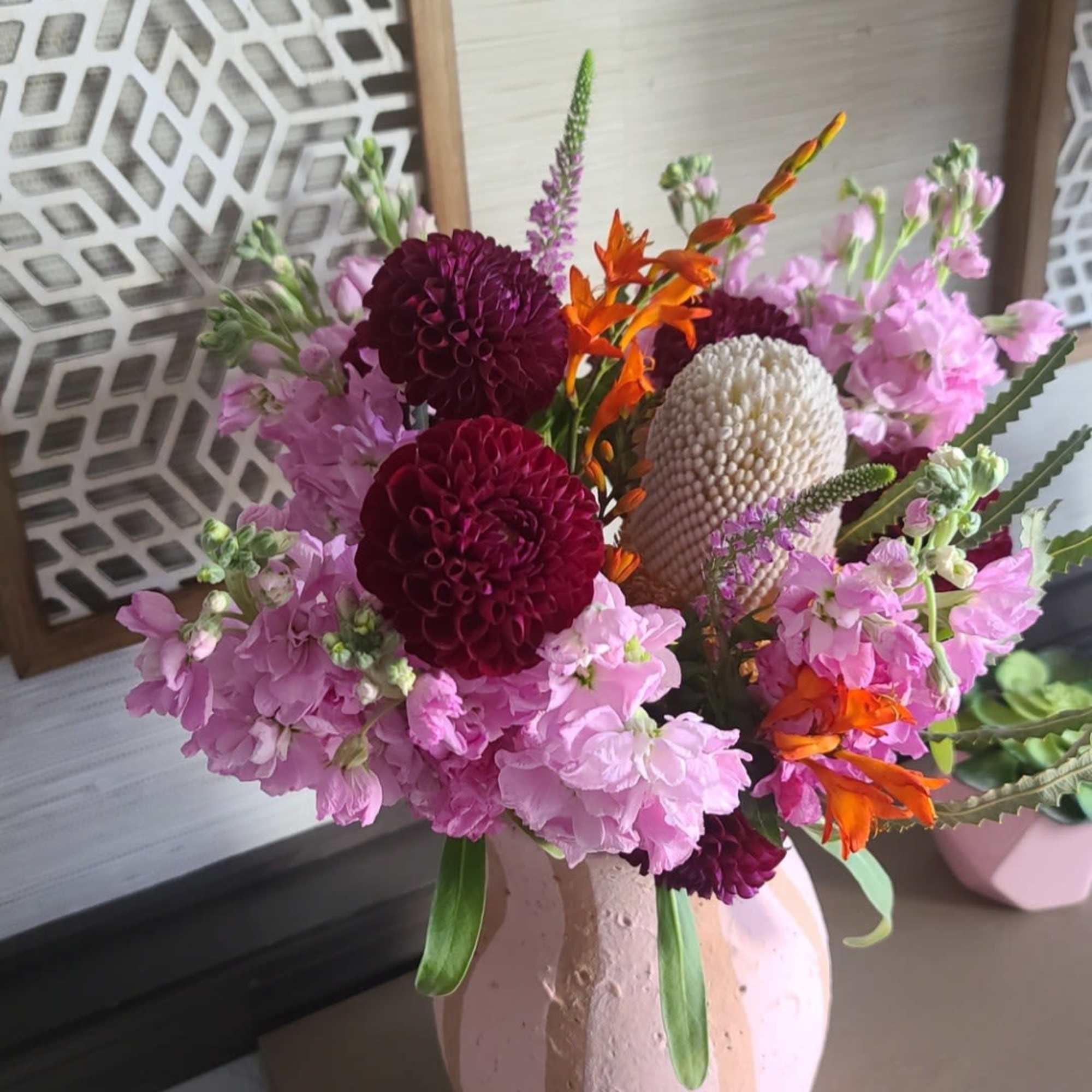 This bouquet is bringing main character energy. With moody maroon dahlias, punchy