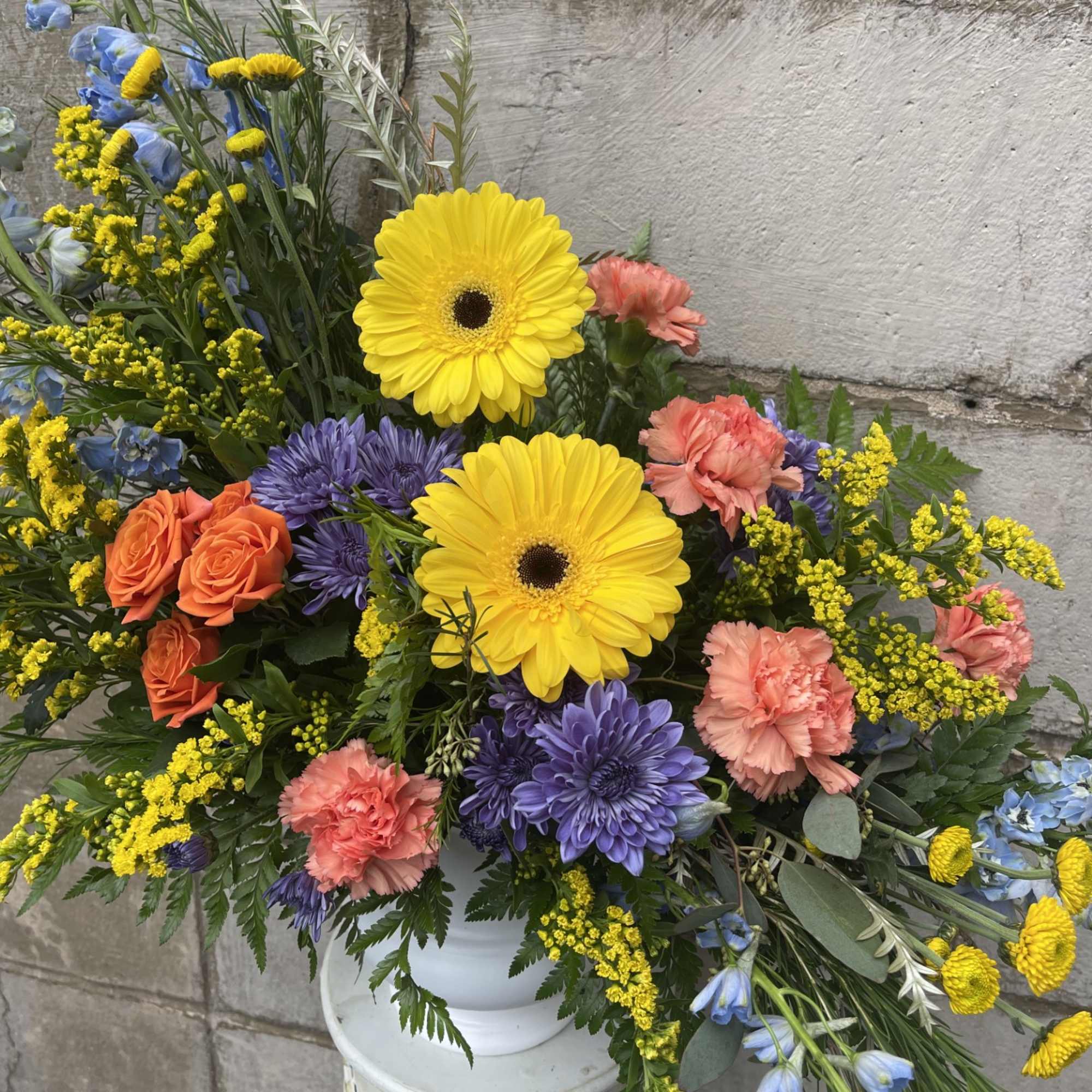 A show stopping arrangement filled with a variety of brightly colored blooms.