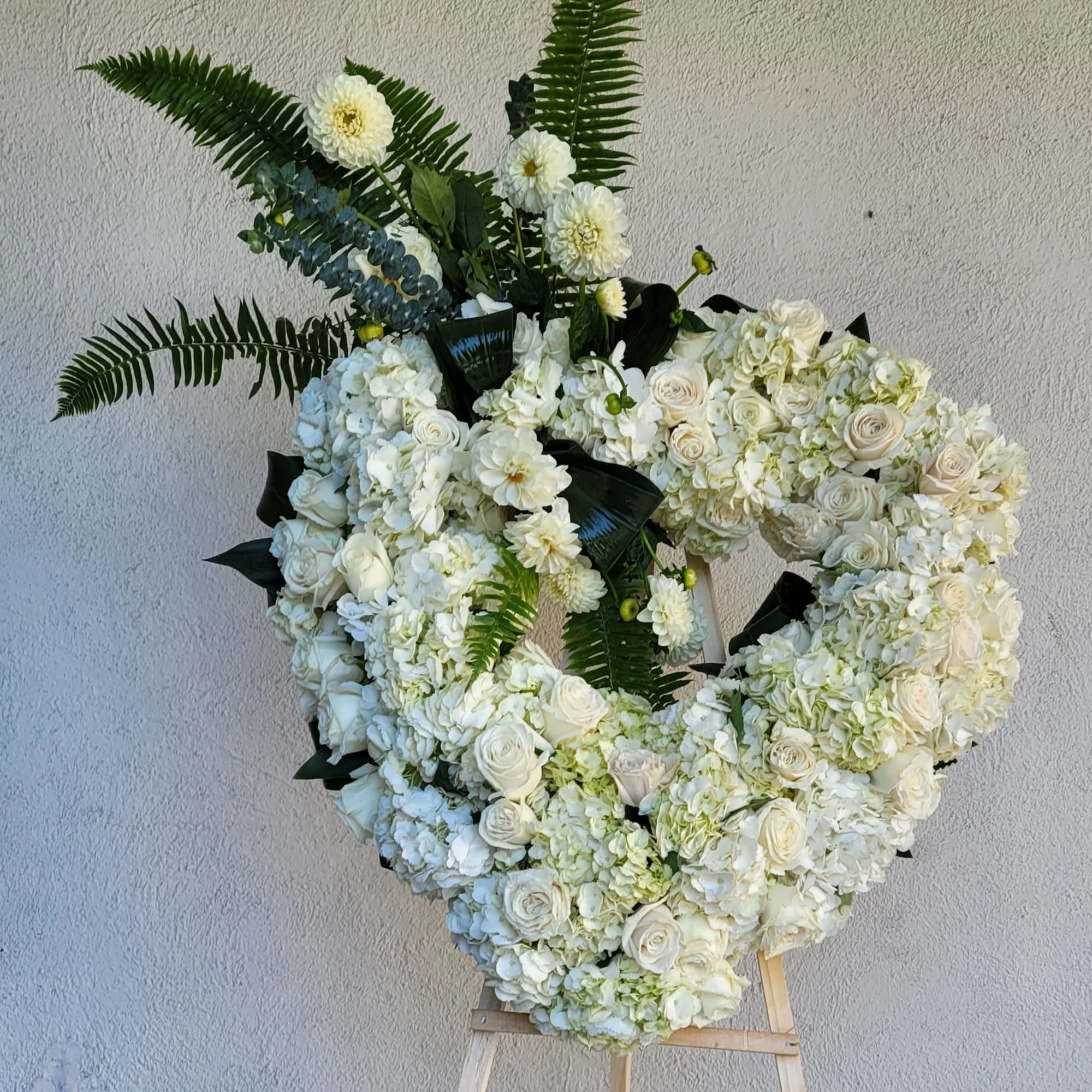 An Opened or Enclosed Heart Floral spray. 
Custom-printed ribbons are available. Please