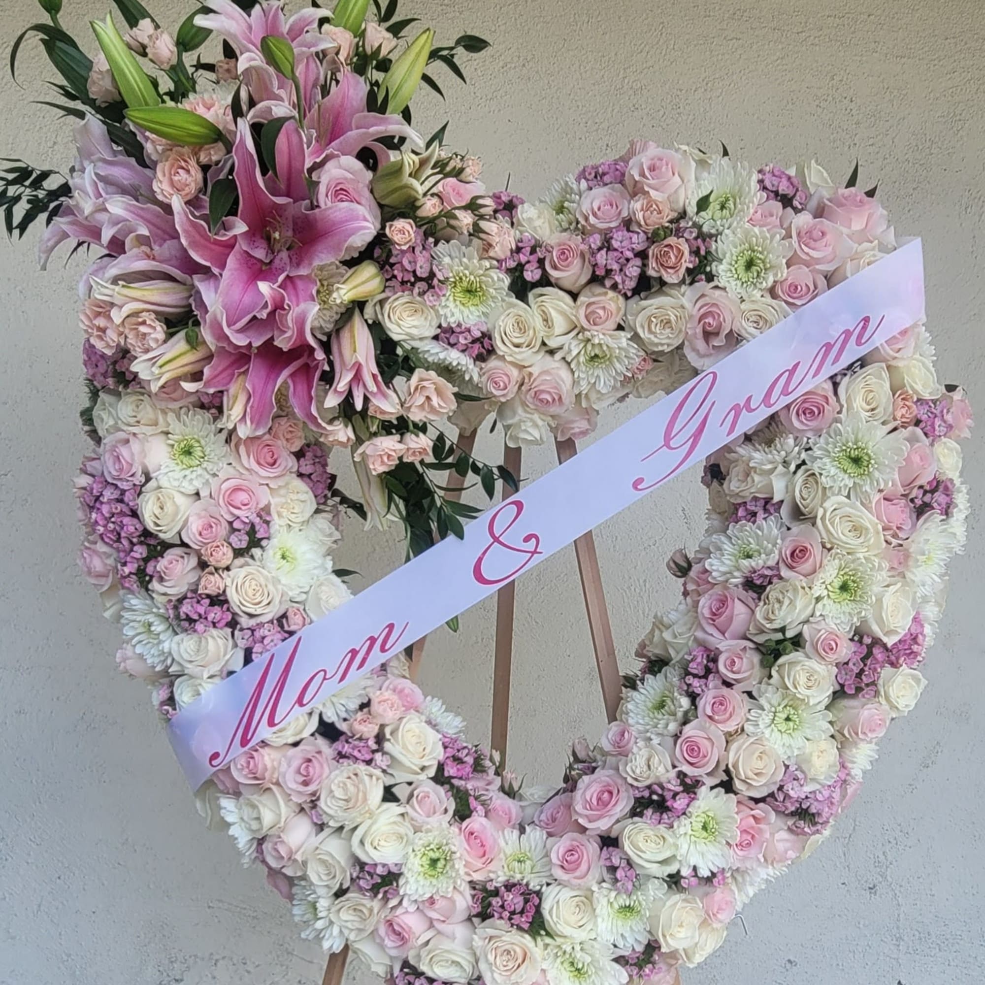 An Opened or Enclosed Heart Floral spray. 
Custom-printed ribbons are available. Please