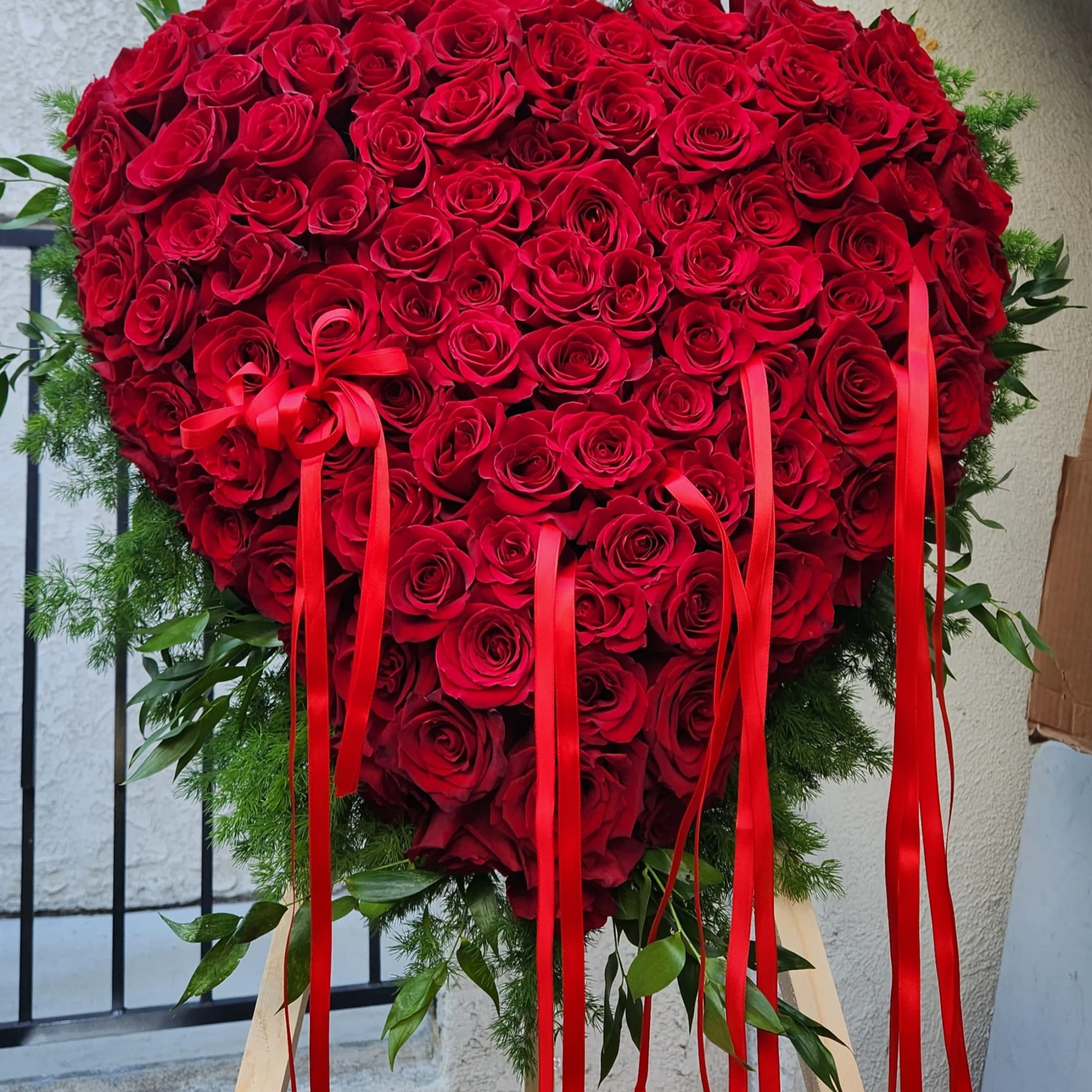 An Opened or Enclosed Heart Floral spray. 
Custom-printed ribbons are available. Please