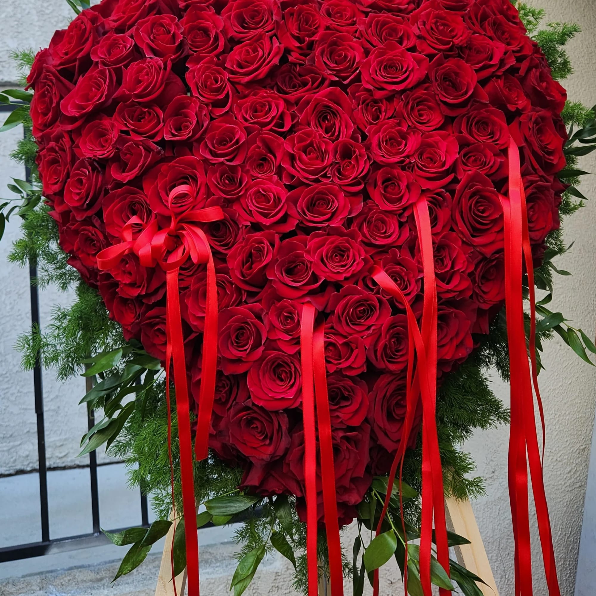 An Opened or Enclosed Heart Floral spray. 
Custom-printed ribbons are available. Please