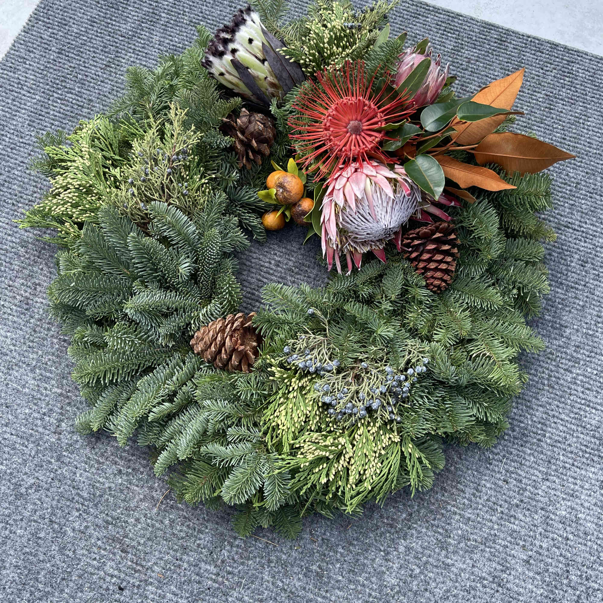 Hawaiian holiday wreath fresh exotic greens locally grown complemented with Oregon Evergreens