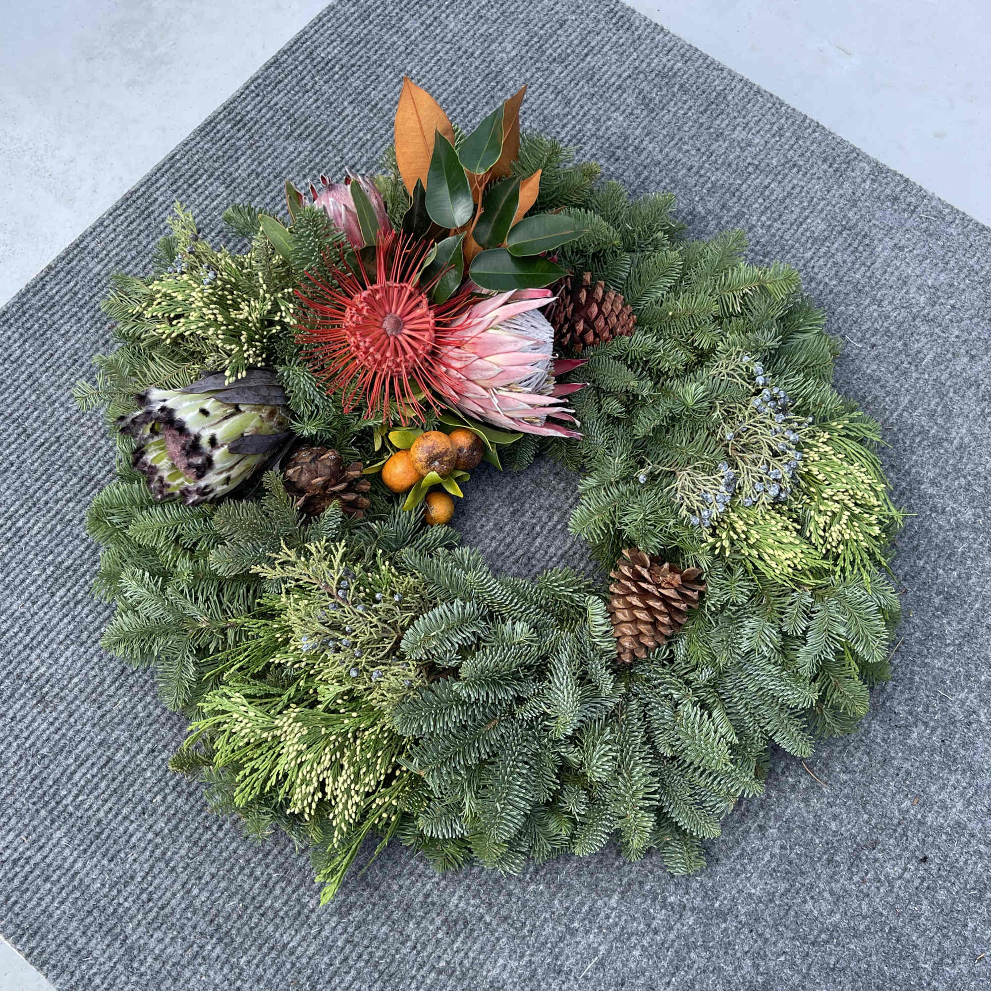 Hawaiian holiday wreath fresh exotic greens locally grown complemented with Oregon Evergreens