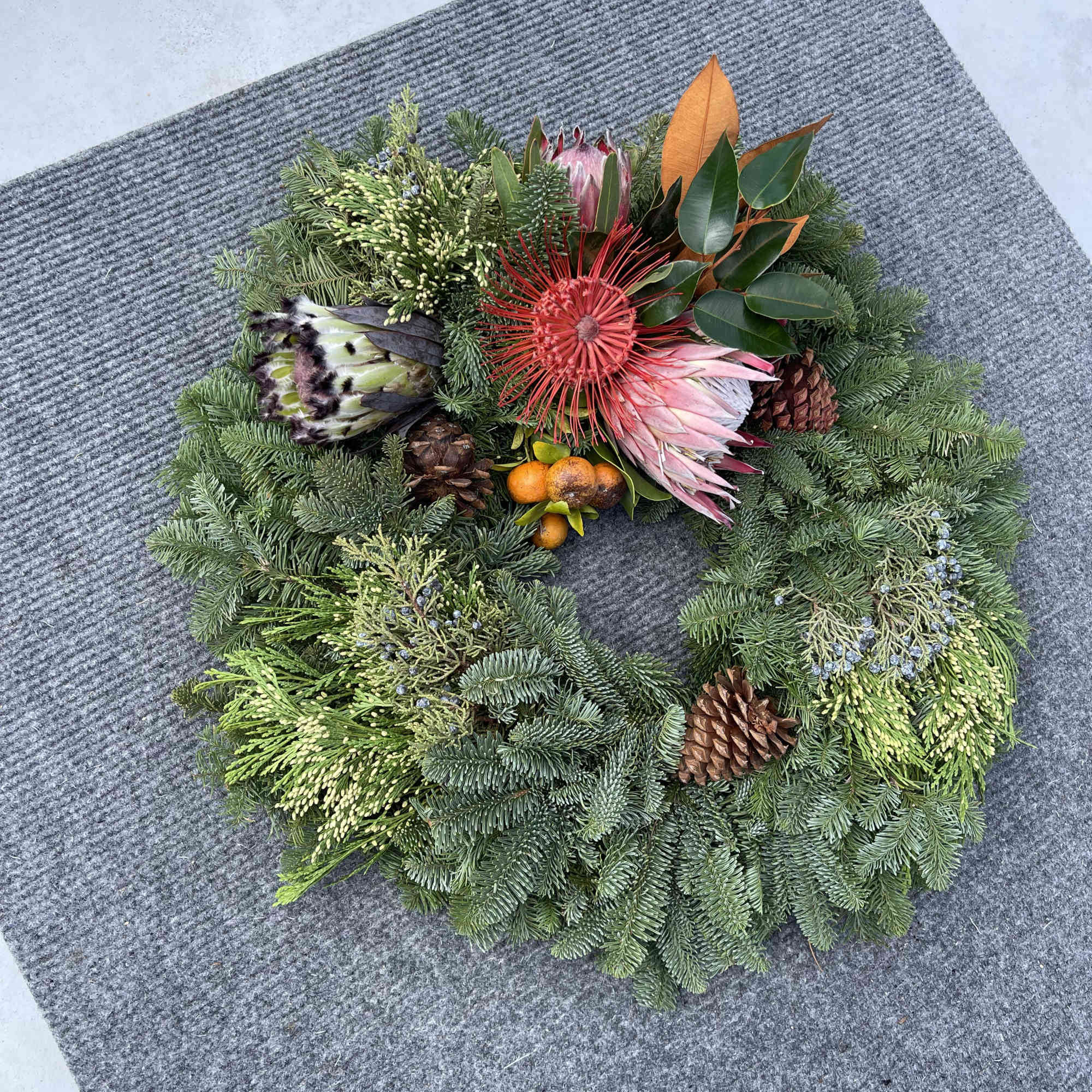 Hawaiian holiday wreath fresh exotic greens locally grown complemented with Oregon Evergreens