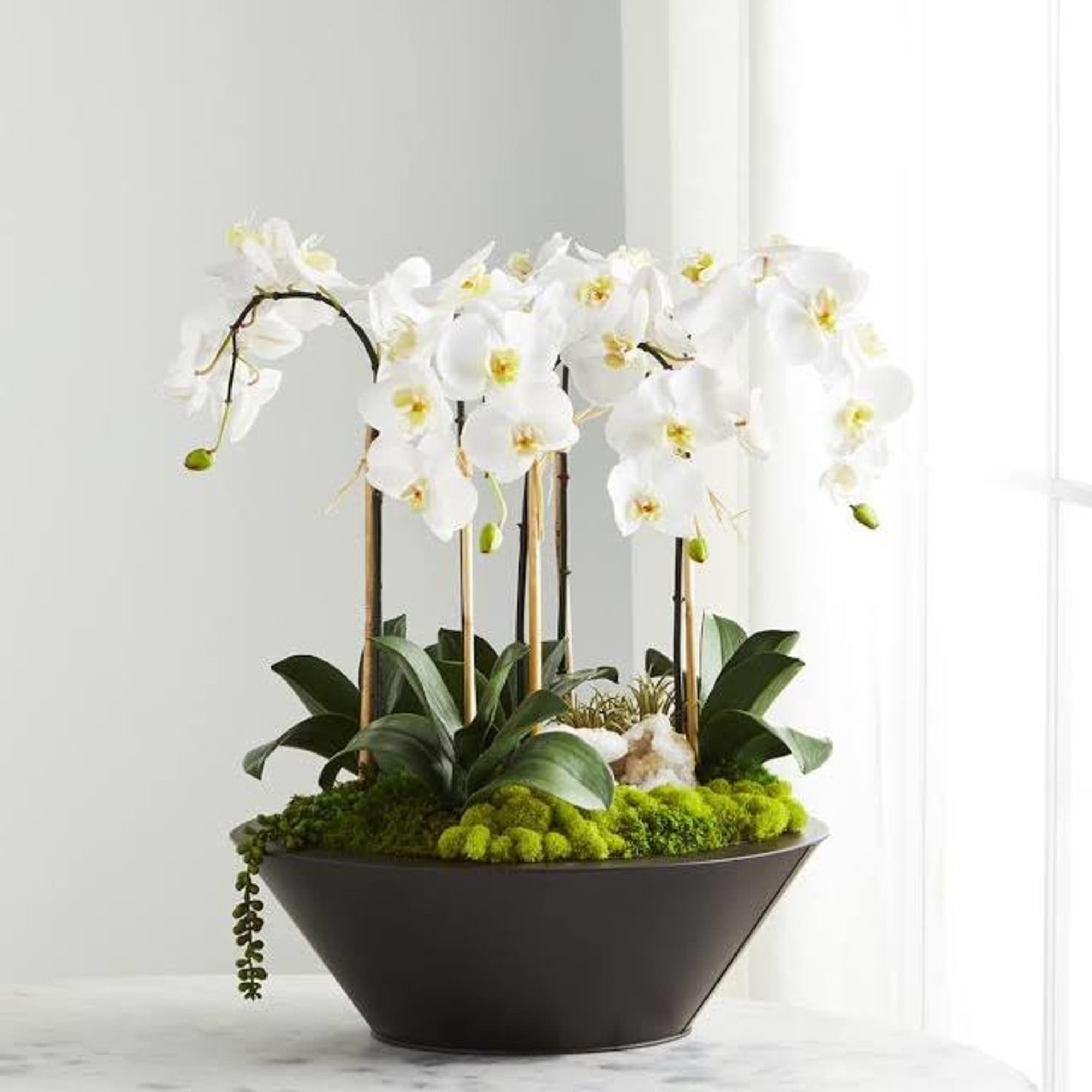 This forever centerpiece is full of silk blooms in a Zen style