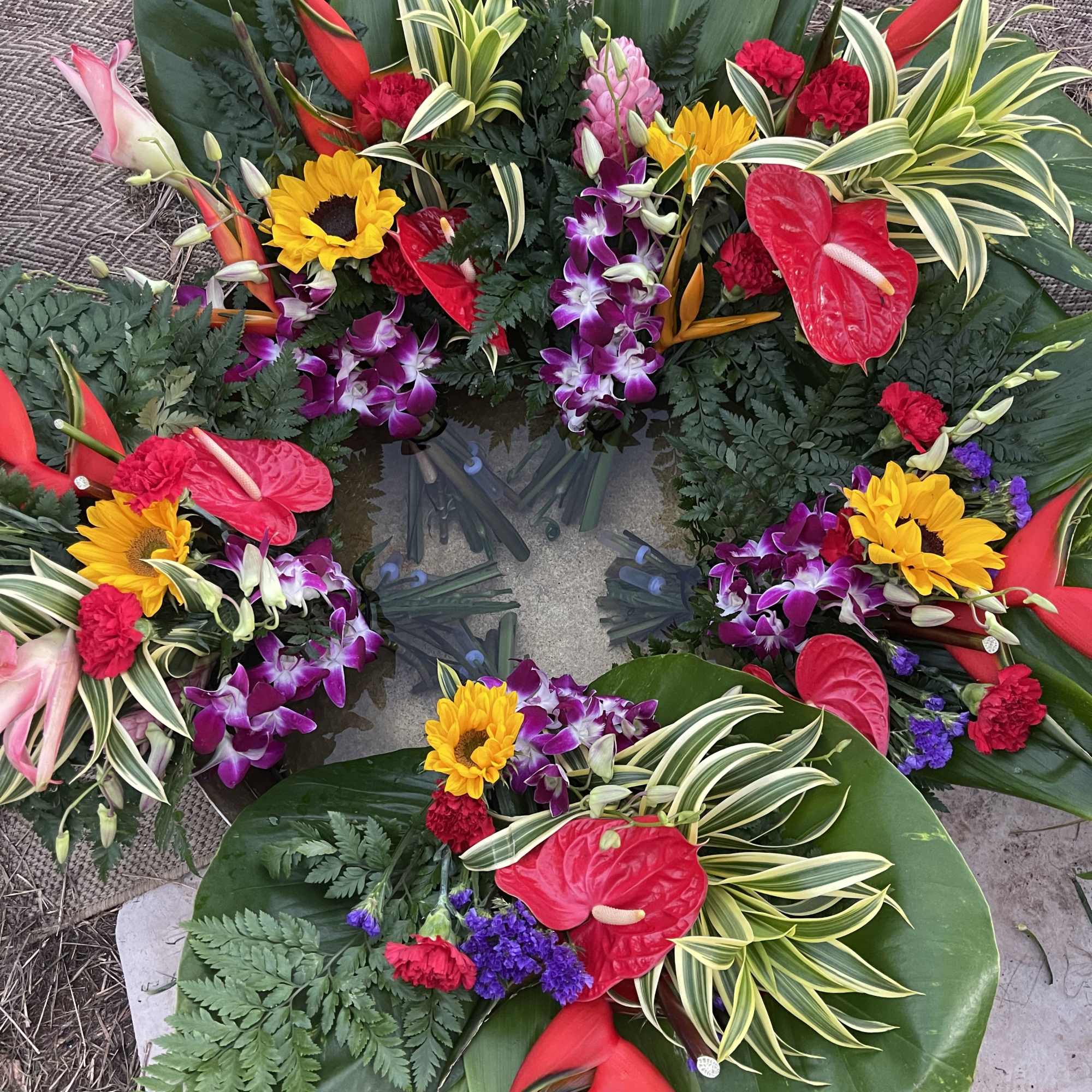 This a large exotic floral bouquet is gently wrapped in floral paper