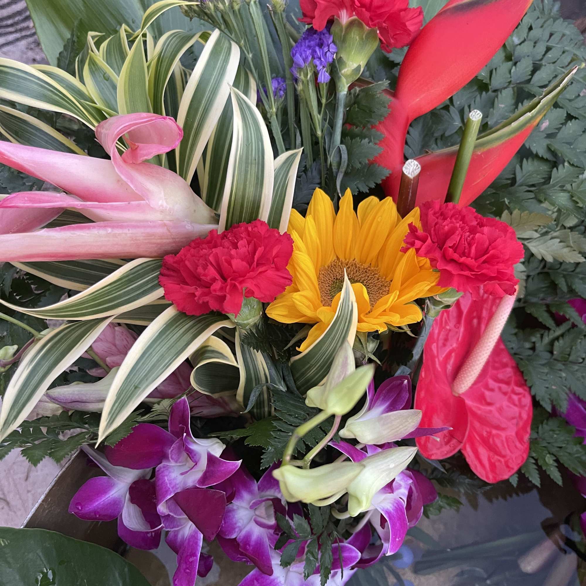 This a large exotic floral bouquet is gently wrapped in floral paper