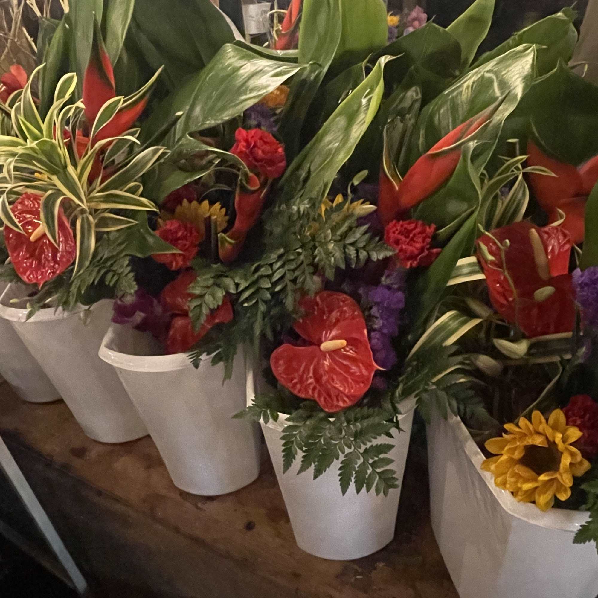 This a large exotic floral bouquet is gently wrapped in floral paper