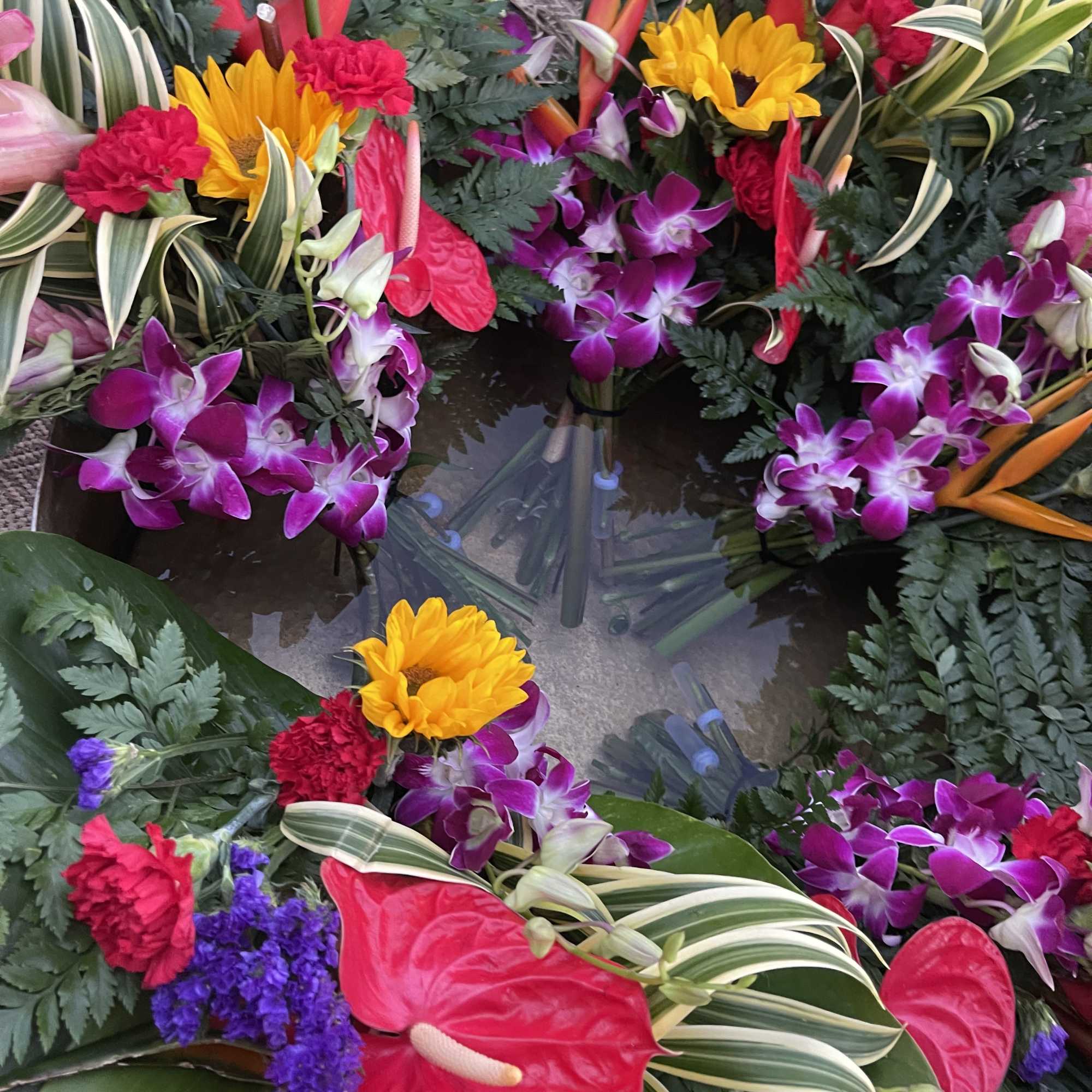 This a large exotic floral bouquet is gently wrapped in floral paper