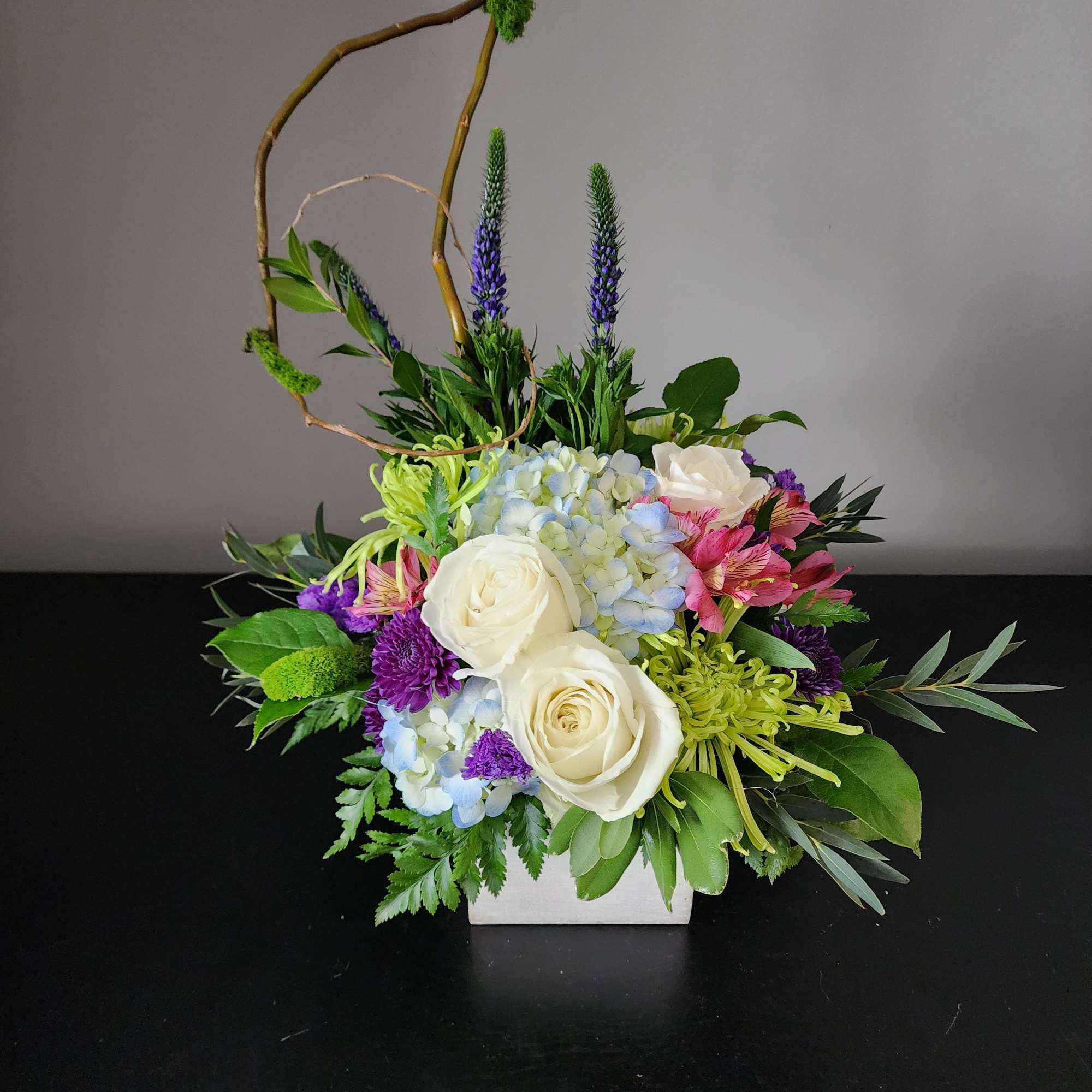 This fresh trendy arrangement is designed in a wooden cube with fugi