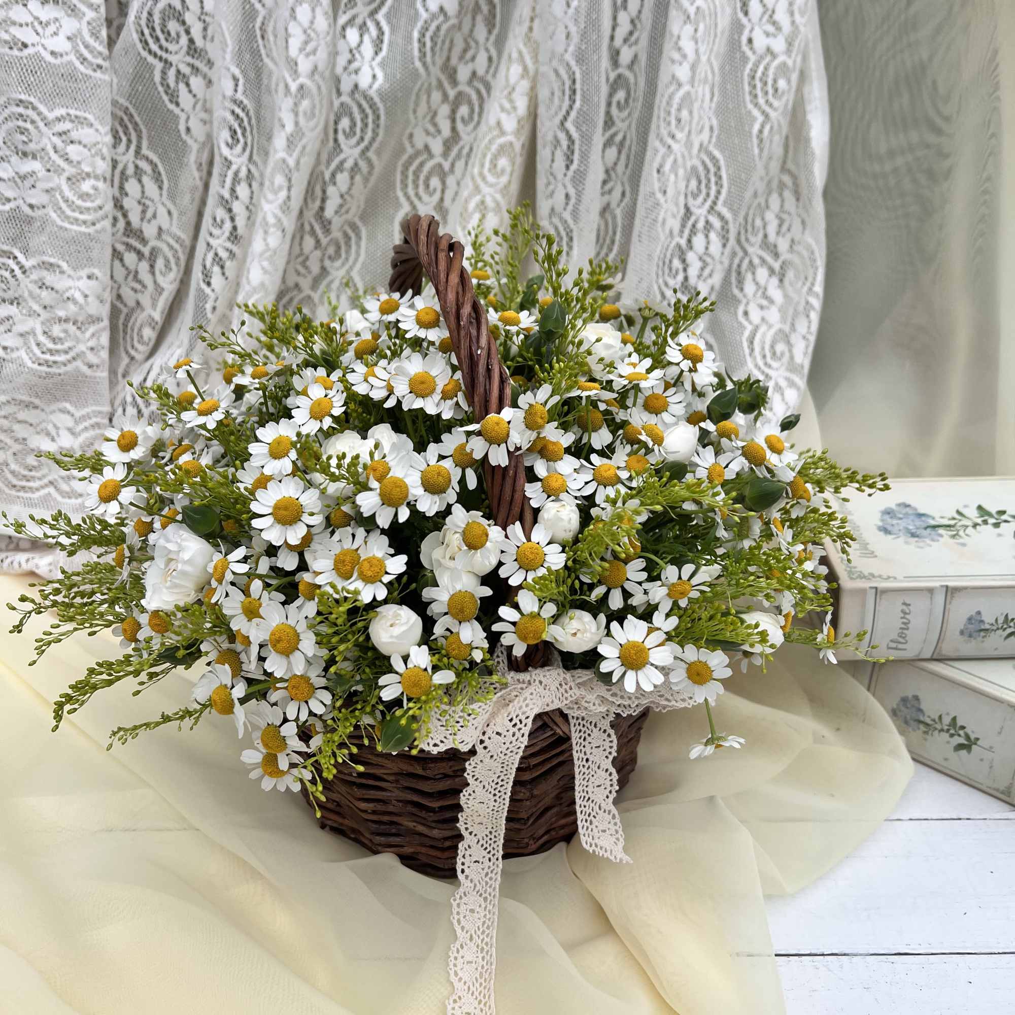This charming basket arrangement features an abundance of pure daisies, symbolizing innocence