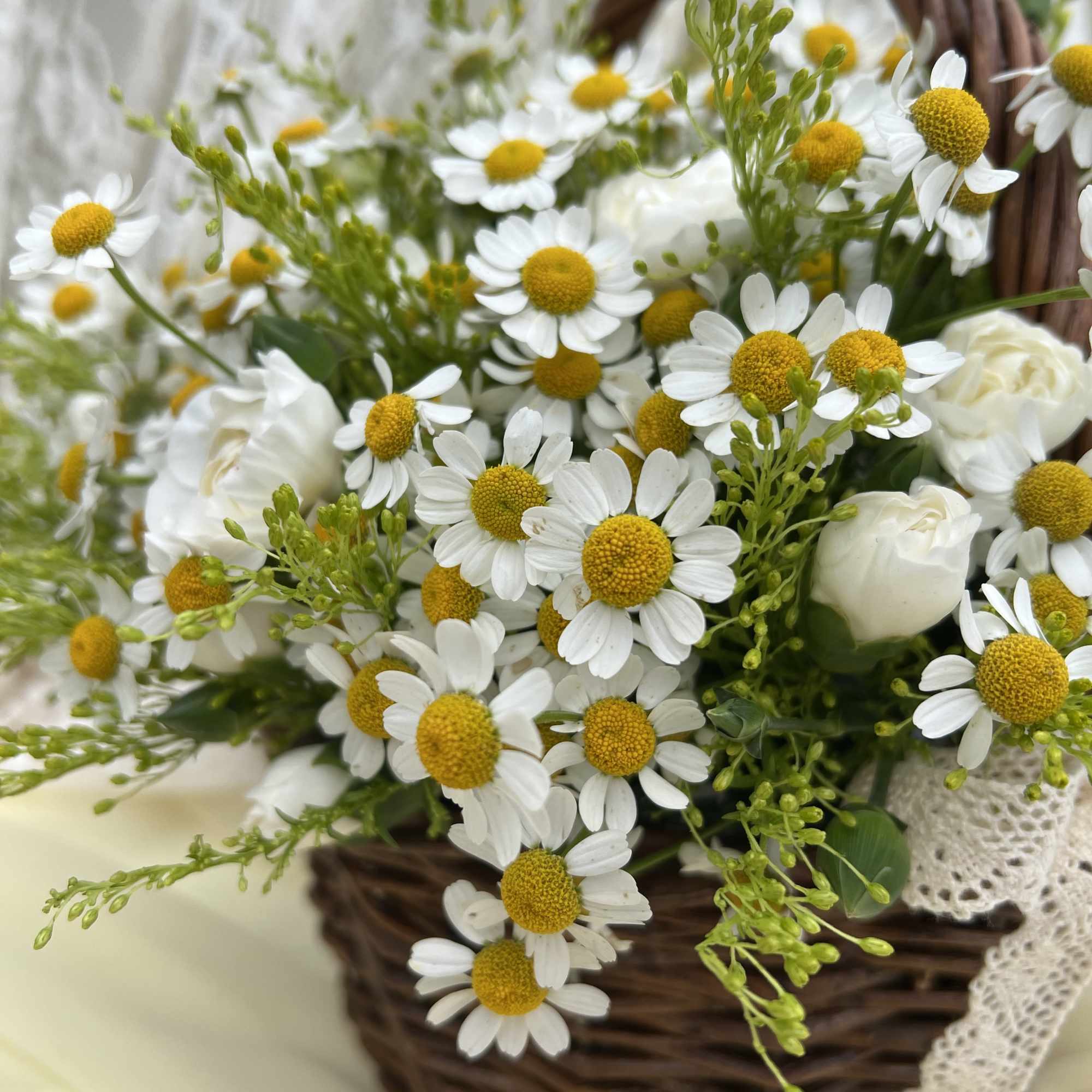 This charming basket arrangement features an abundance of pure daisies, symbolizing innocence