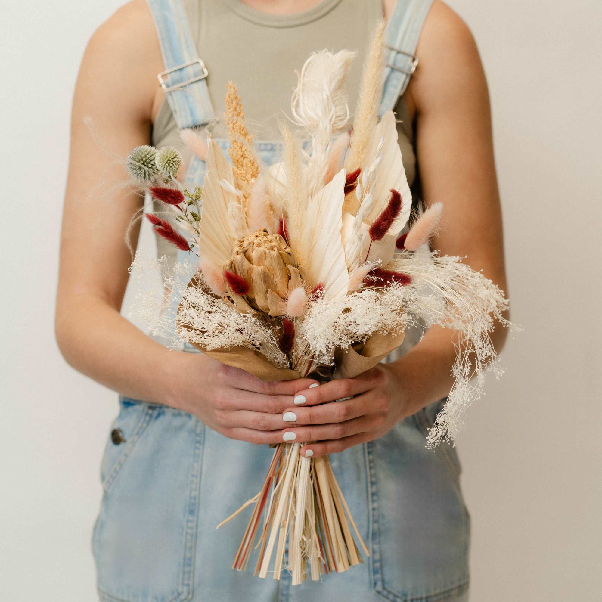 Our large dried hand-tied bouquet is a striking arrangement of preserved blooms