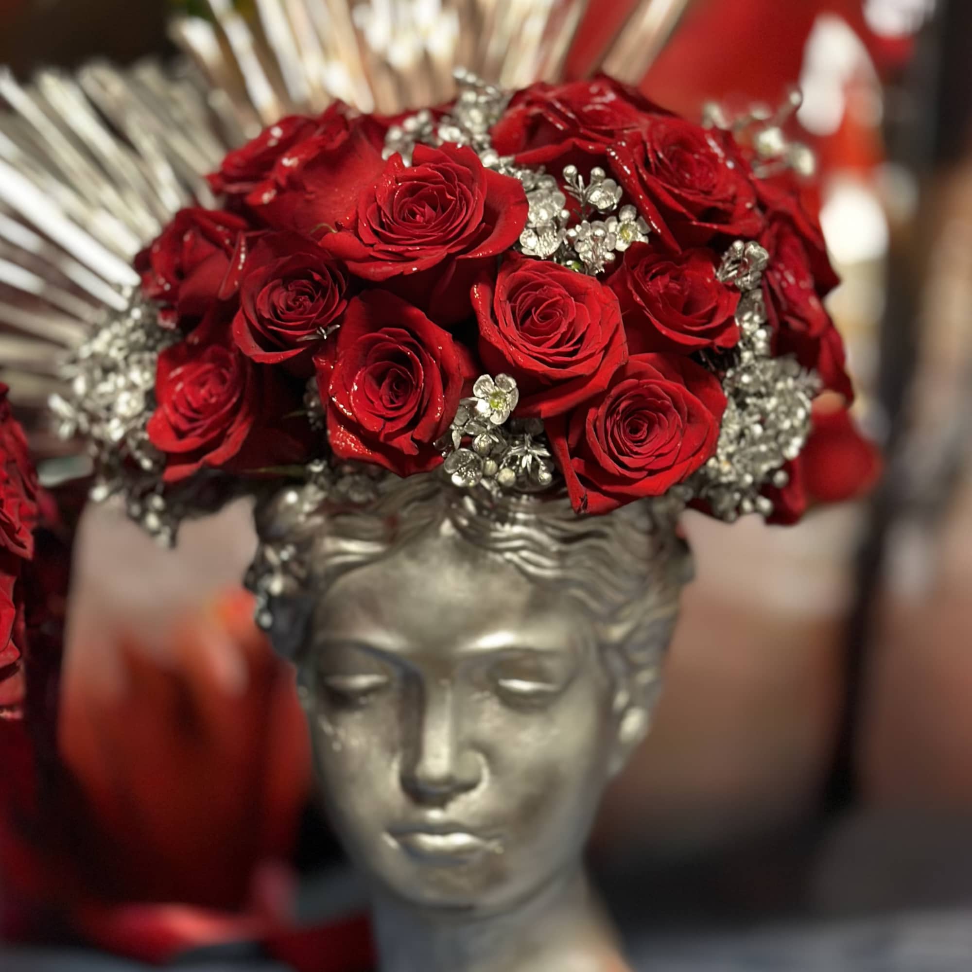 Designed in a silver Grecian-style bust vase, this unique floral piece blends