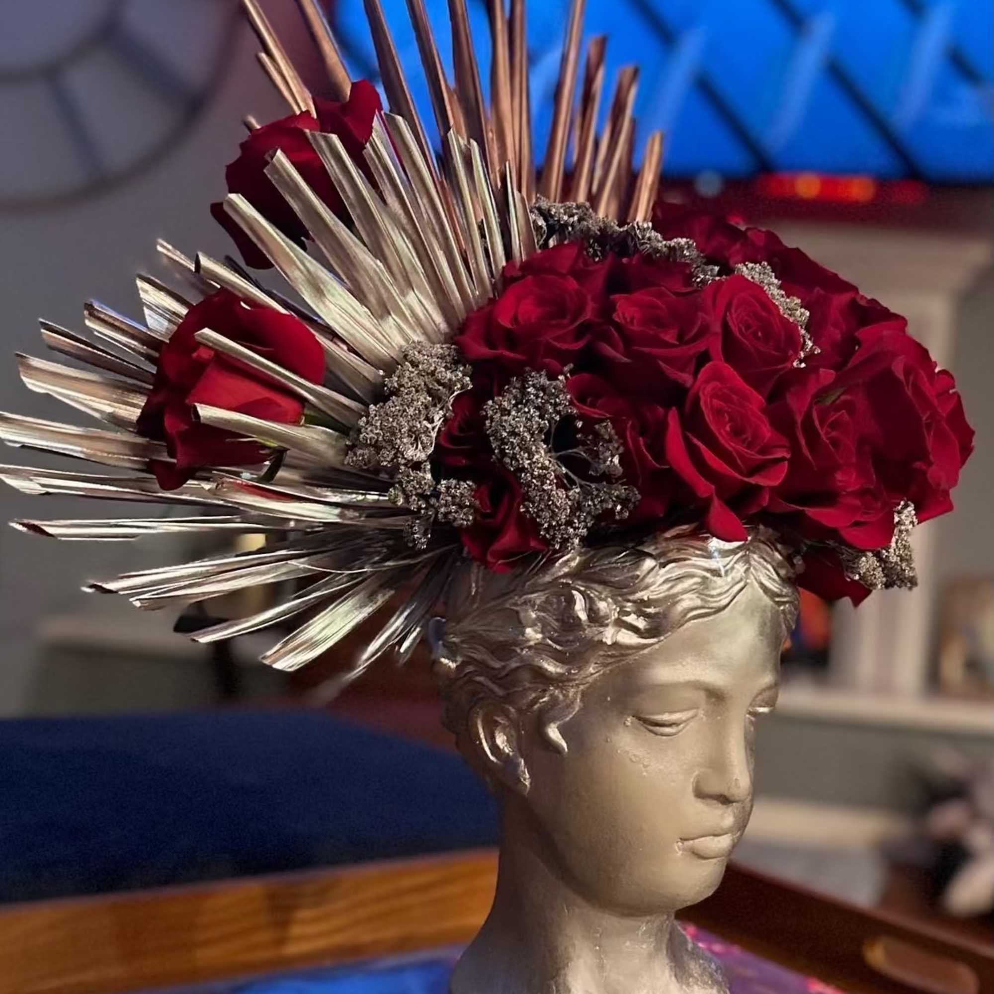 Designed in a silver Grecian-style bust vase, this unique floral piece blends