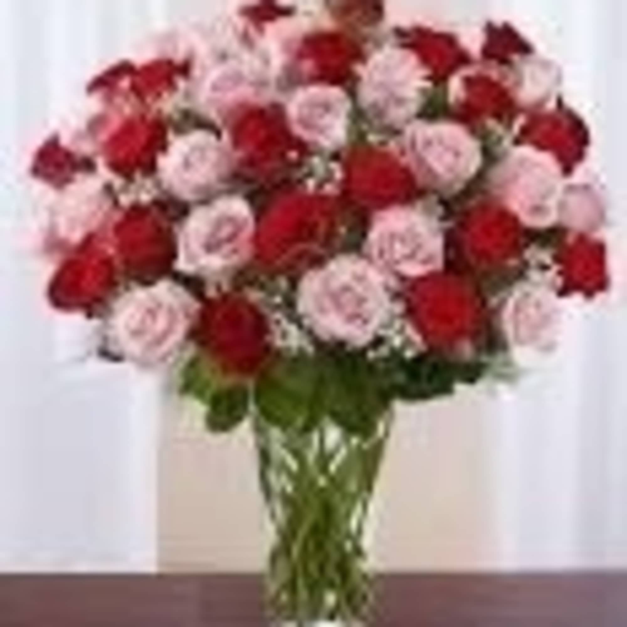 12 Red and Pink Roses arranged in a vase