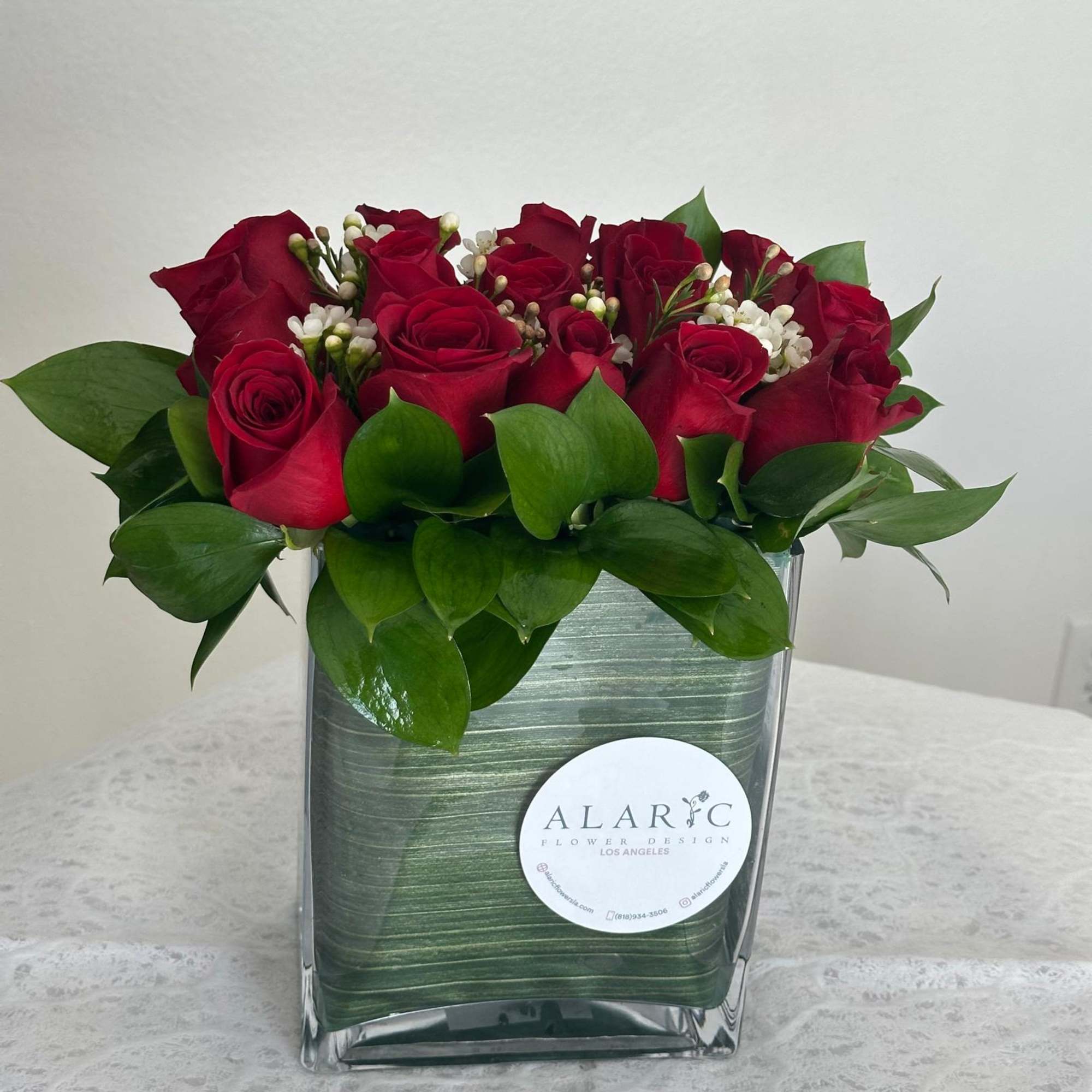 This bold and romantic arrangement is all about passion! Deep red roses