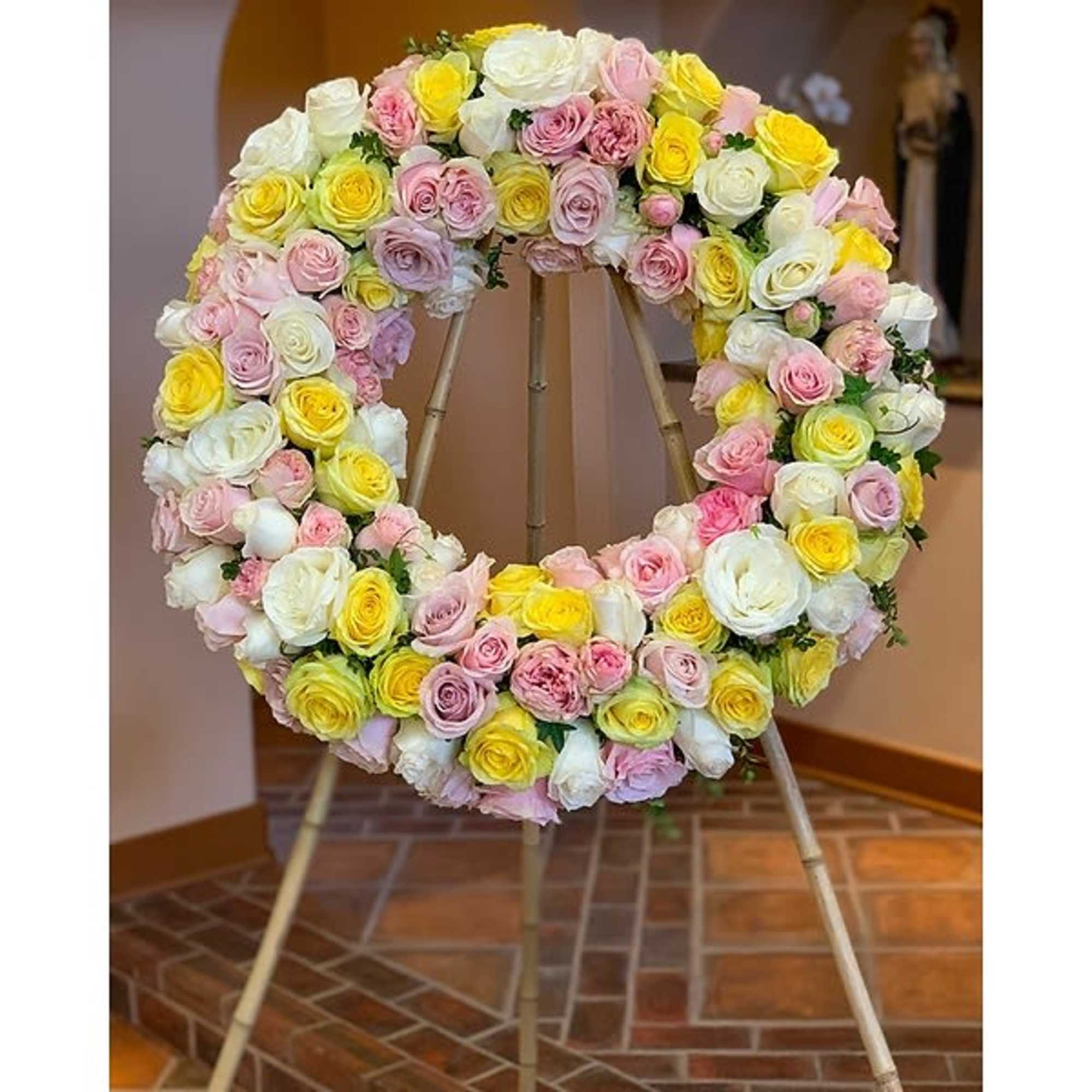 A wreath of multicolor or single color roses. A beautful tribute for