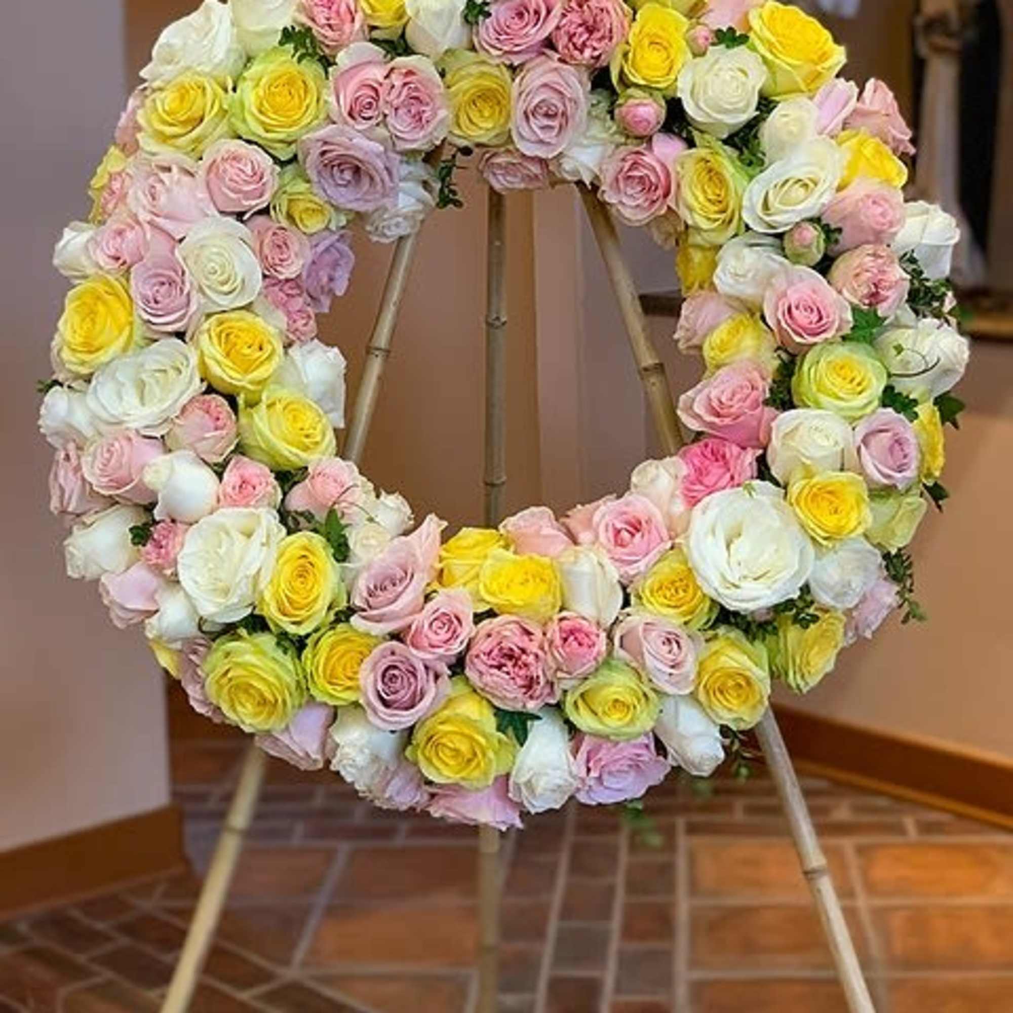 A wreath of multicolor or single color roses. A beautful tribute for