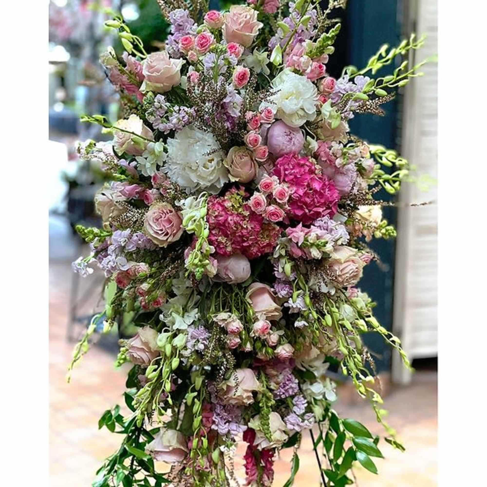 Pastel, seasonal flowers set on an easel, perfect for a Celebration of