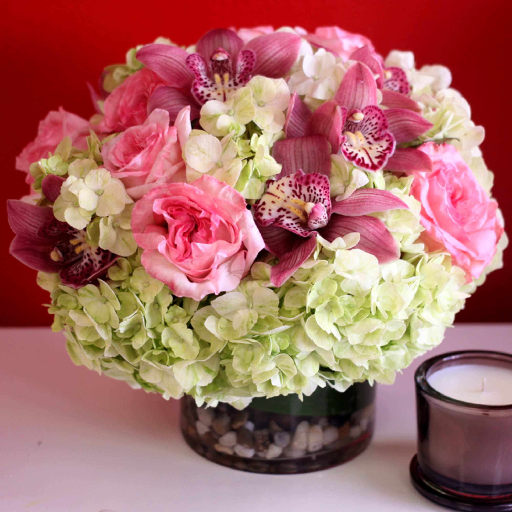 A dazzling bouquet of lush pink cymbidium orchids and roses designed on