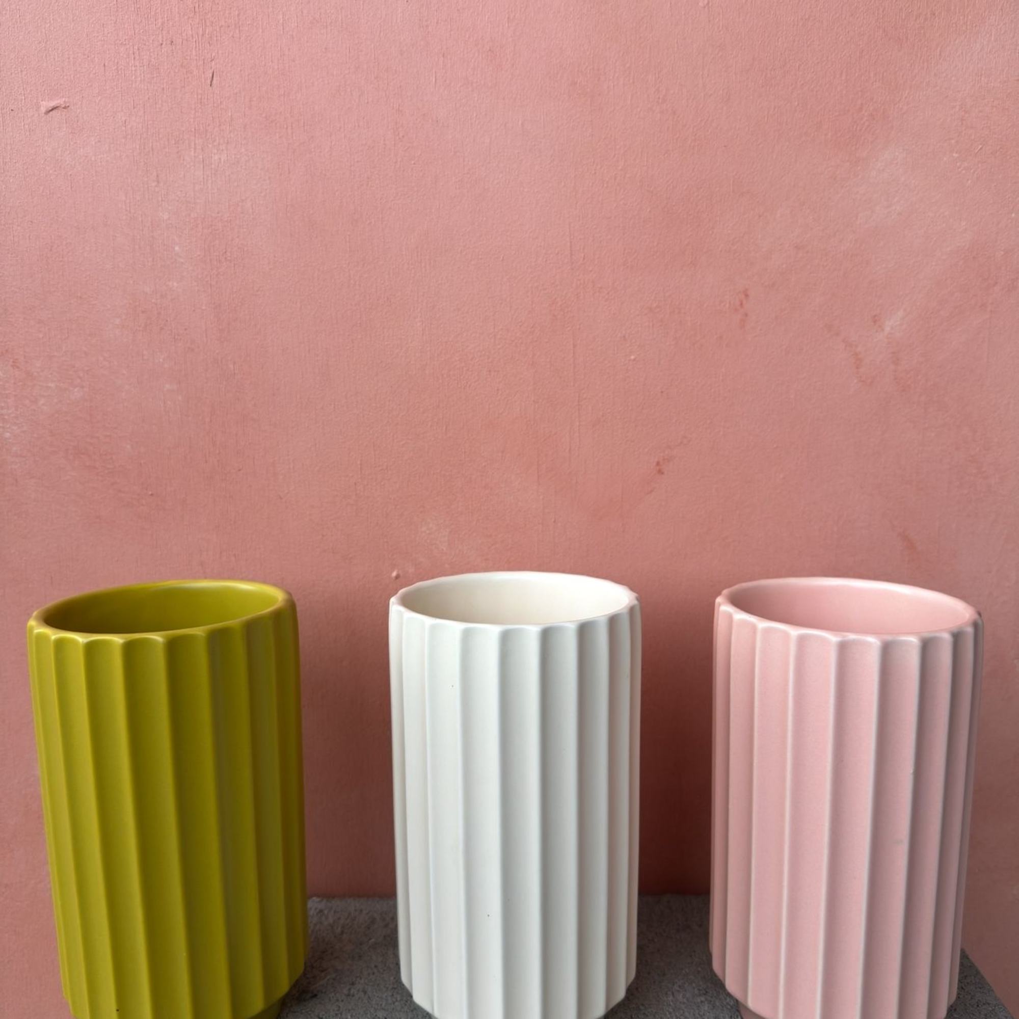 A blossoming arrangement artfully placed in a tall fluted vase that makes