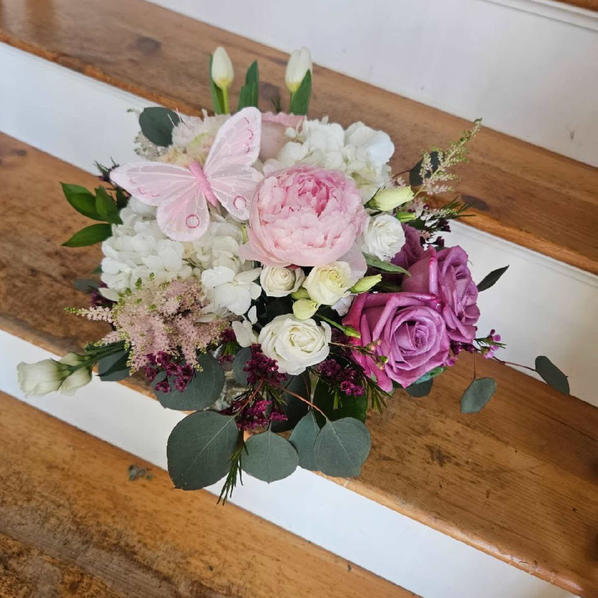 Peonies, hydrangea, roses, spray roses, lisianthis, tulips, astilbe and filler arranged in