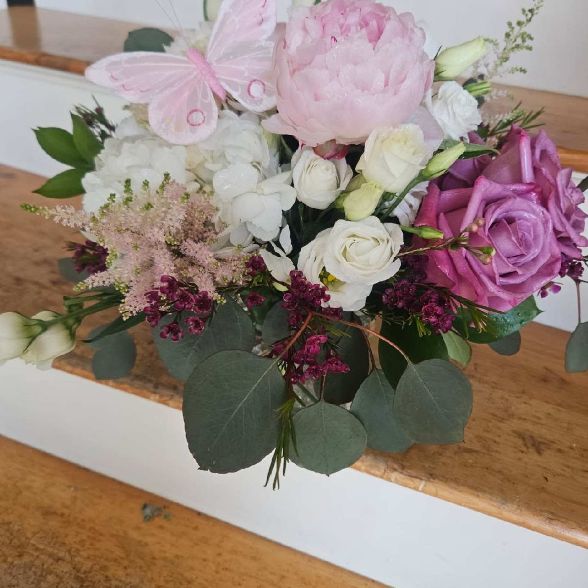 Peonies, hydrangea, roses, spray roses, lisianthis, tulips, astilbe and filler arranged in