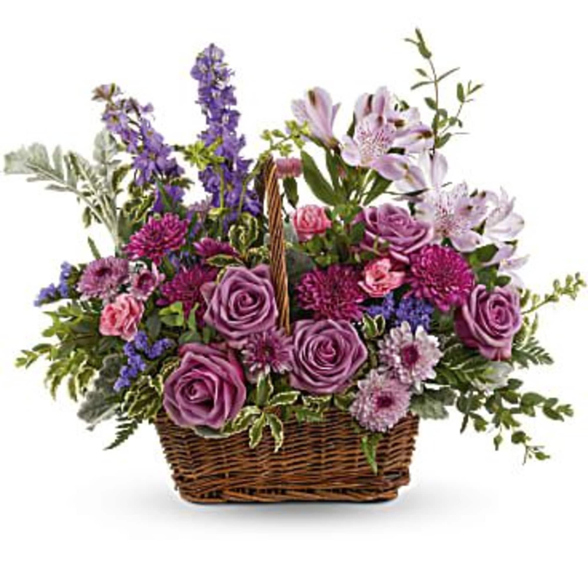 This bouquet features lavender roses, lavender alstroemeria, miniature pink carnations, lavender larkspur