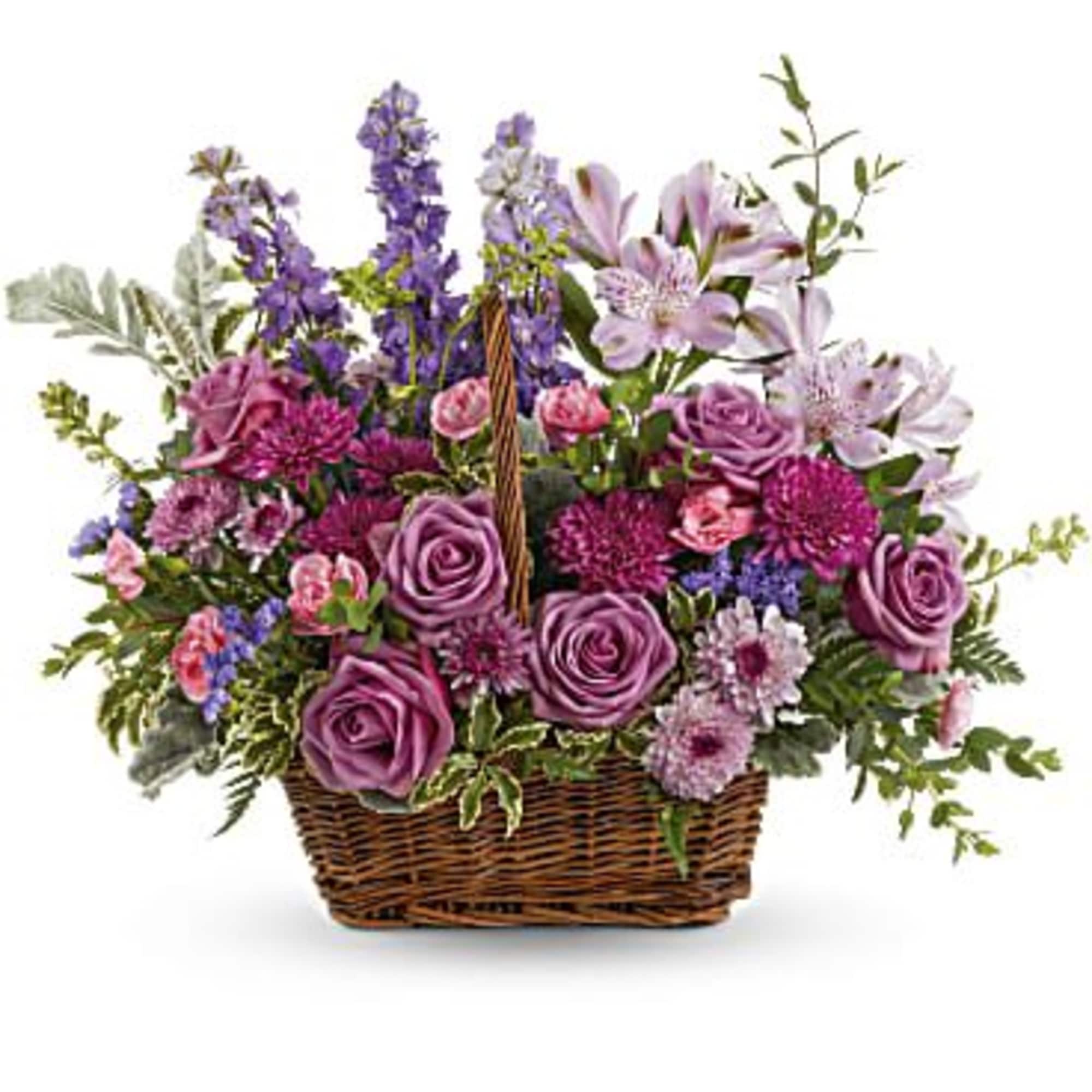 This bouquet features lavender roses, lavender alstroemeria, miniature pink carnations, lavender larkspur