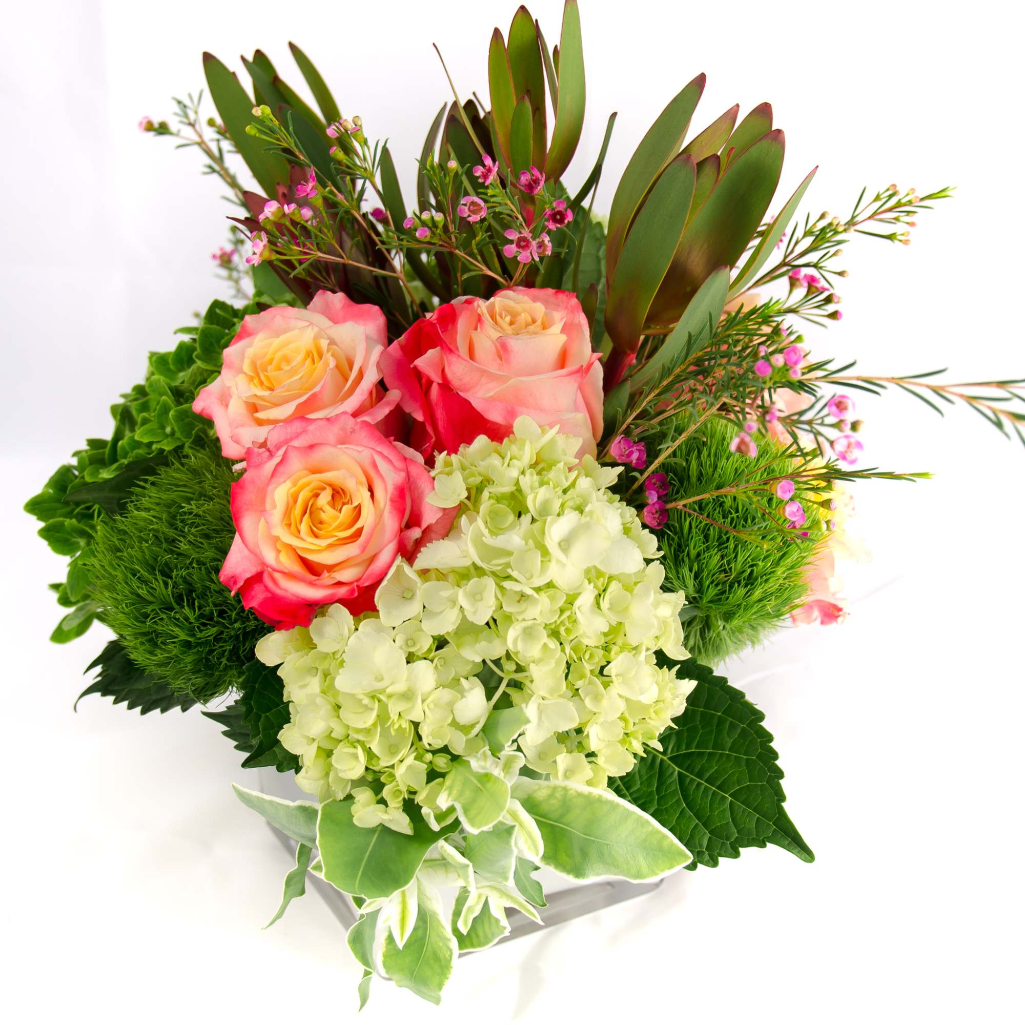 Bright and colorful arrangement, low compact design in white cubed vase. Cheer