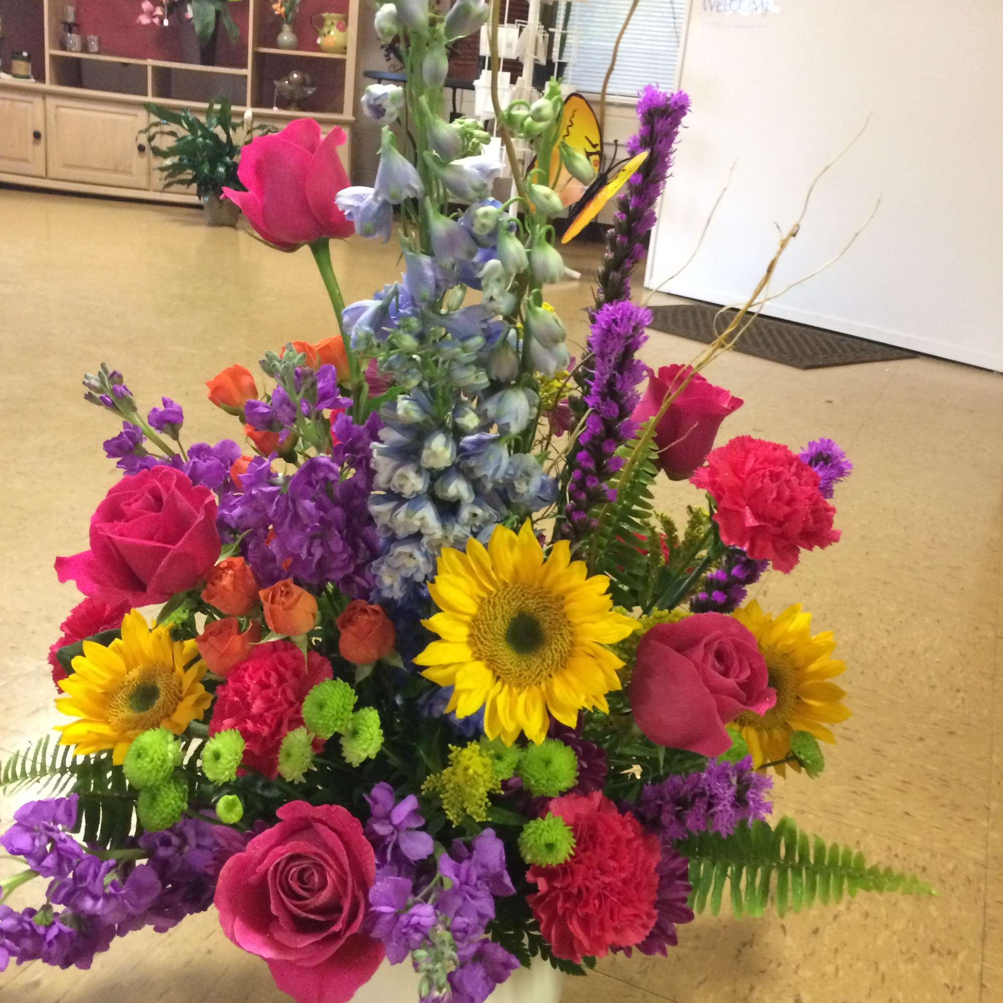 This bright and colorful arrangement is a cheerful combination of hot pink