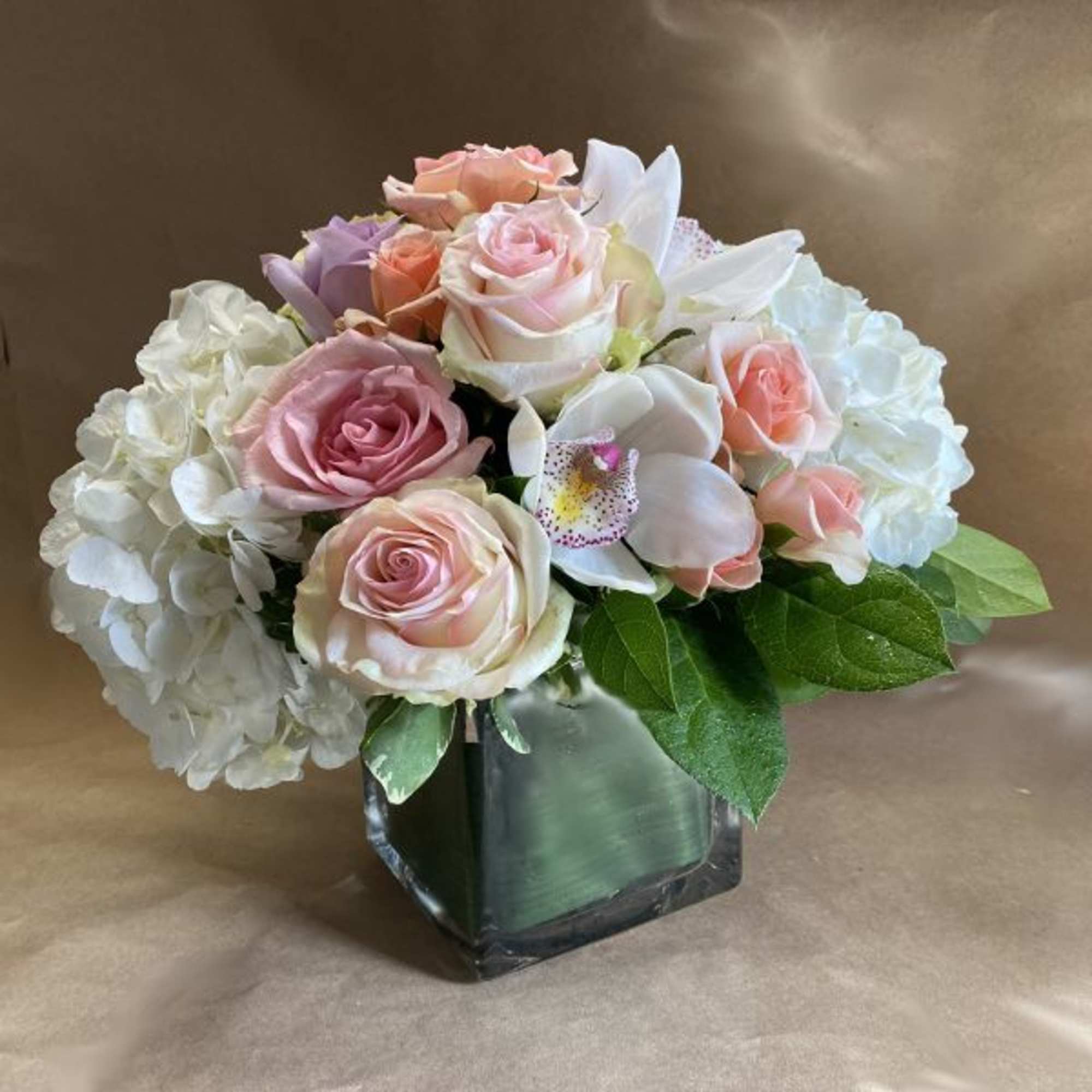 A luscious and elegant arrangement of flowers in pastel shades of peach
