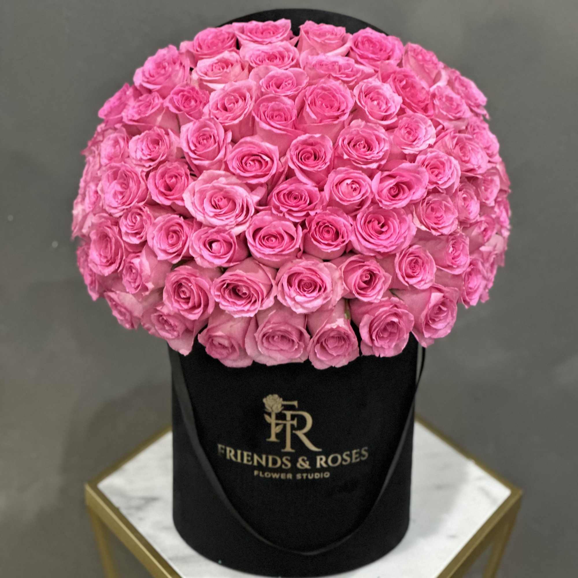 A lovely arrangement of 75 pink roses in our black signature box