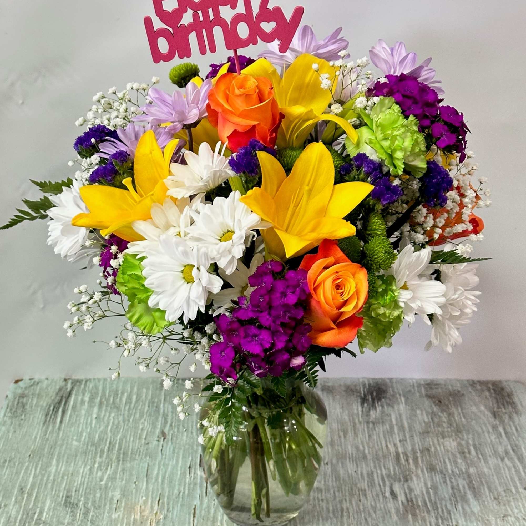 Arrangement of mixed flowers. Colorful and cheerful, includes "happy birthday" pick. Please Arrangement of mixed flowers. Colorful and cheerful, includes "happy birthday" pick. Please