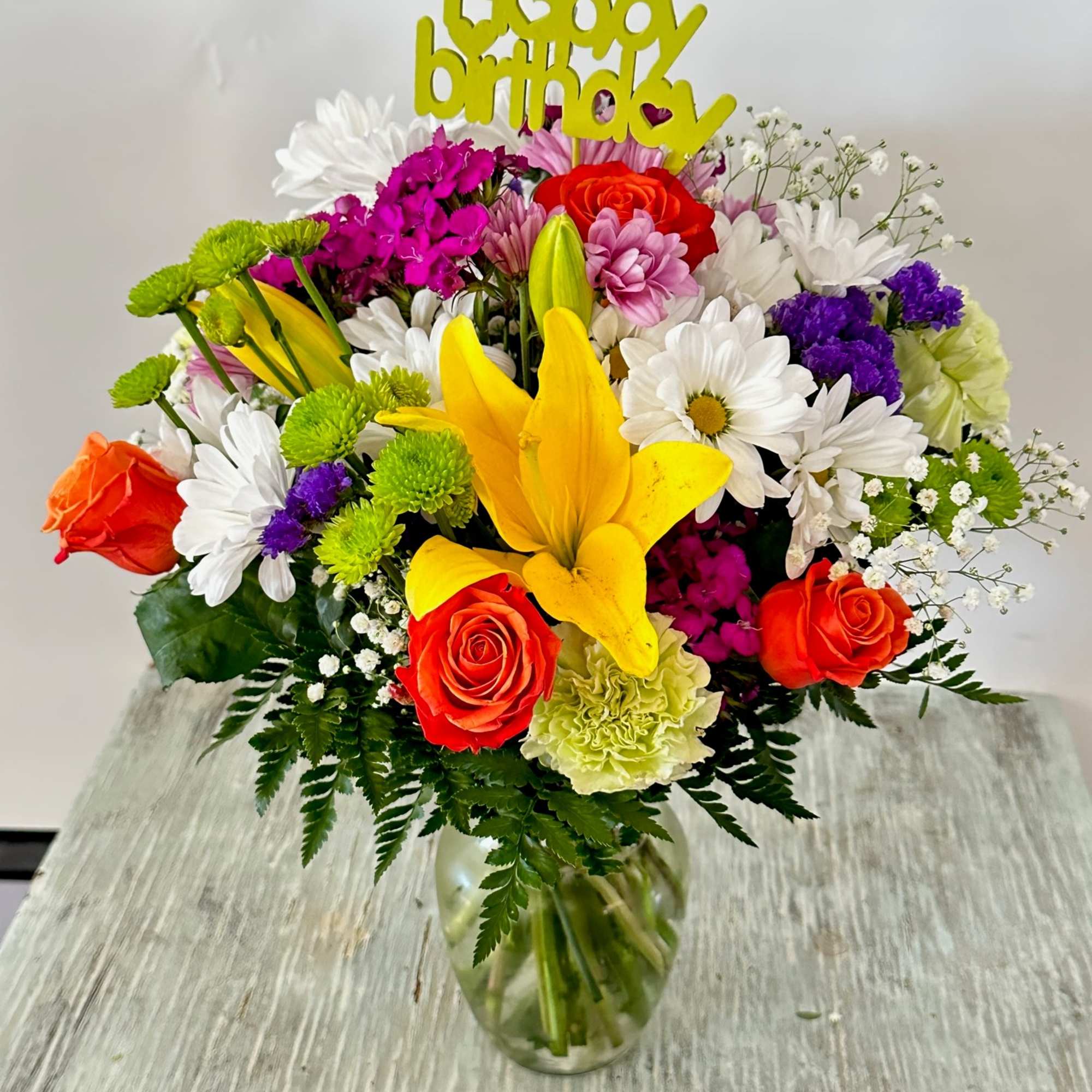 Arrangement of mixed flowers. Colorful and cheerful, includes "happy birthday" pick. Please Arrangement of mixed flowers. Colorful and cheerful, includes "happy birthday" pick. Please