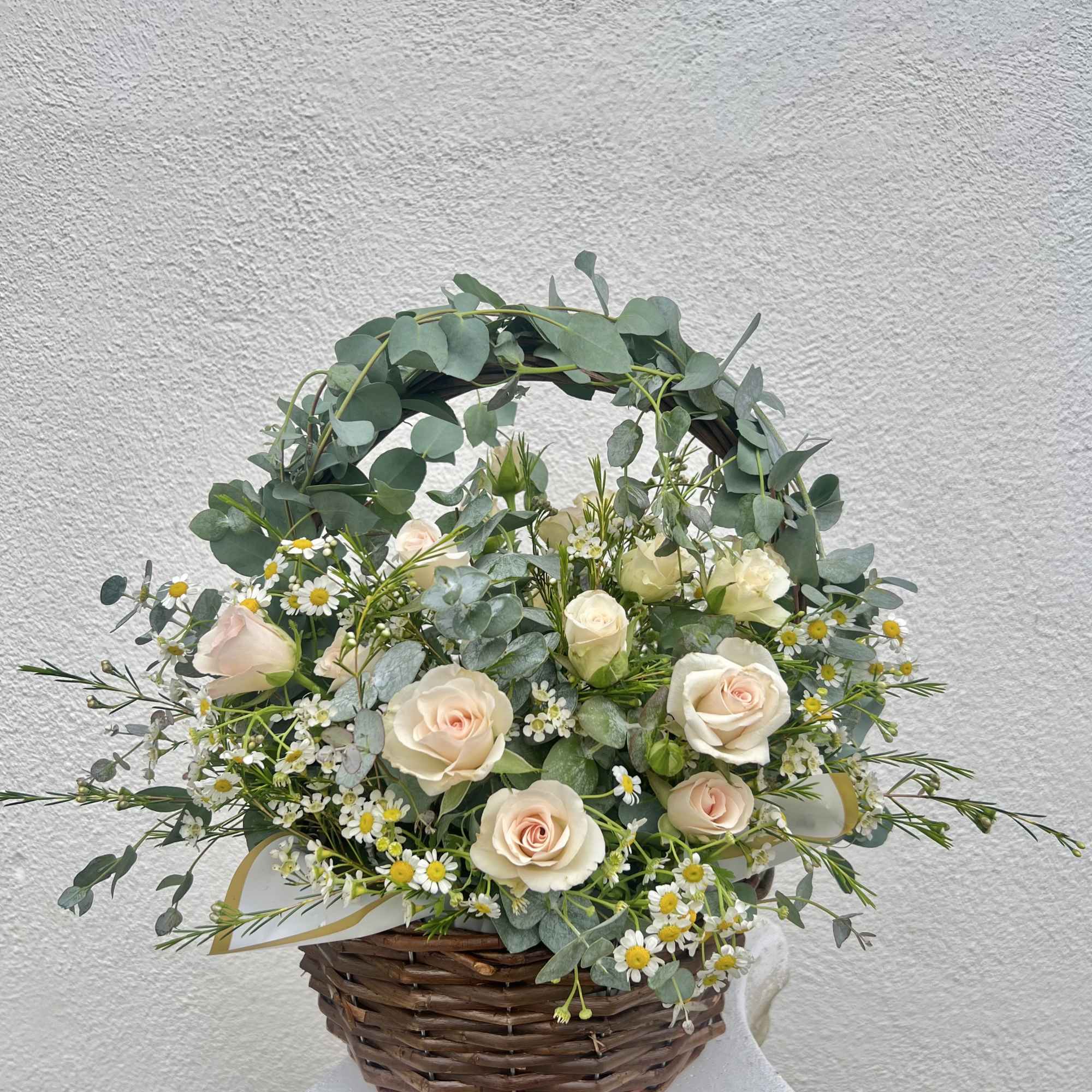 13&rdquo; woven wicker basket fulled with beautiful florals and greenery like Spray