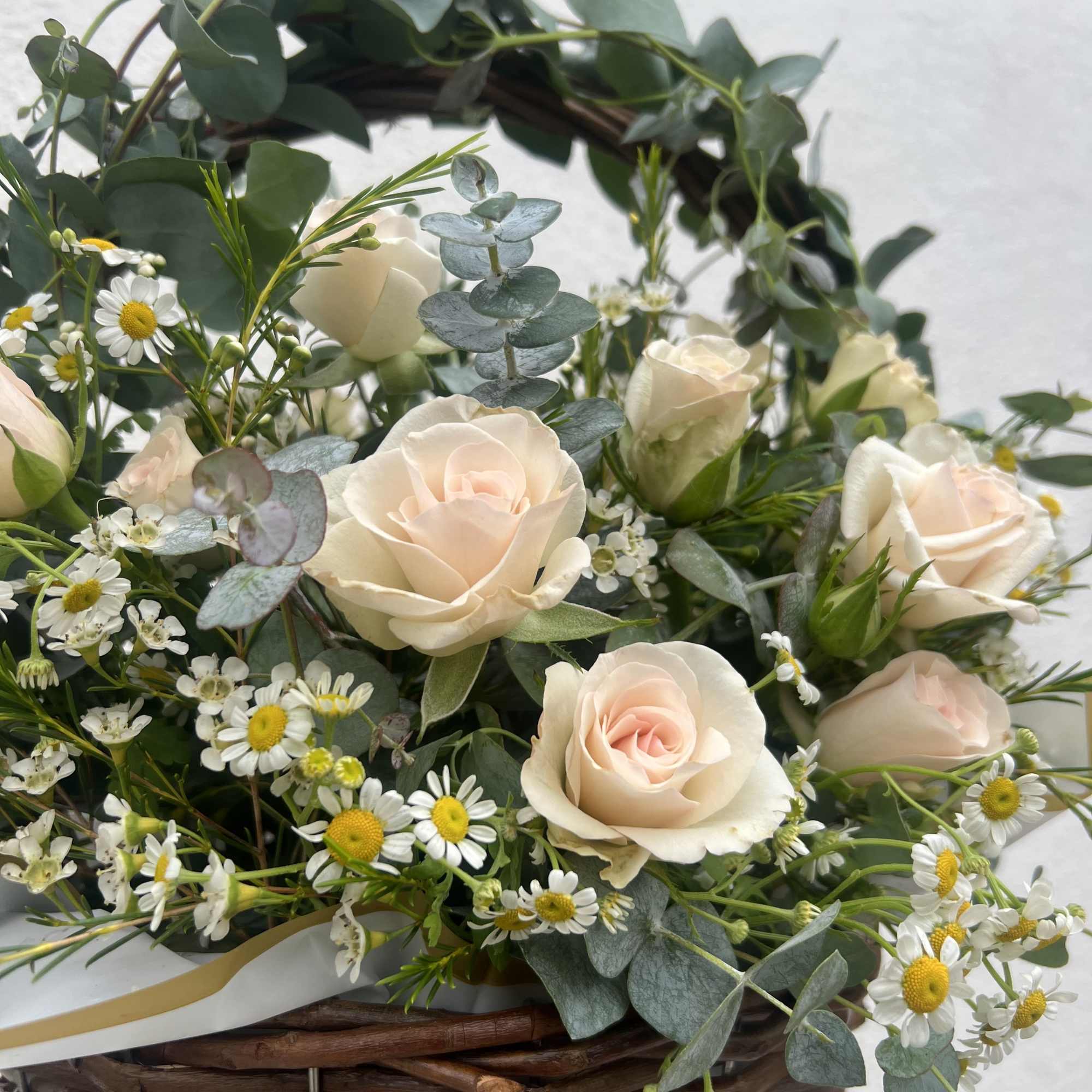 13&rdquo; woven wicker basket fulled with beautiful florals and greenery like Spray